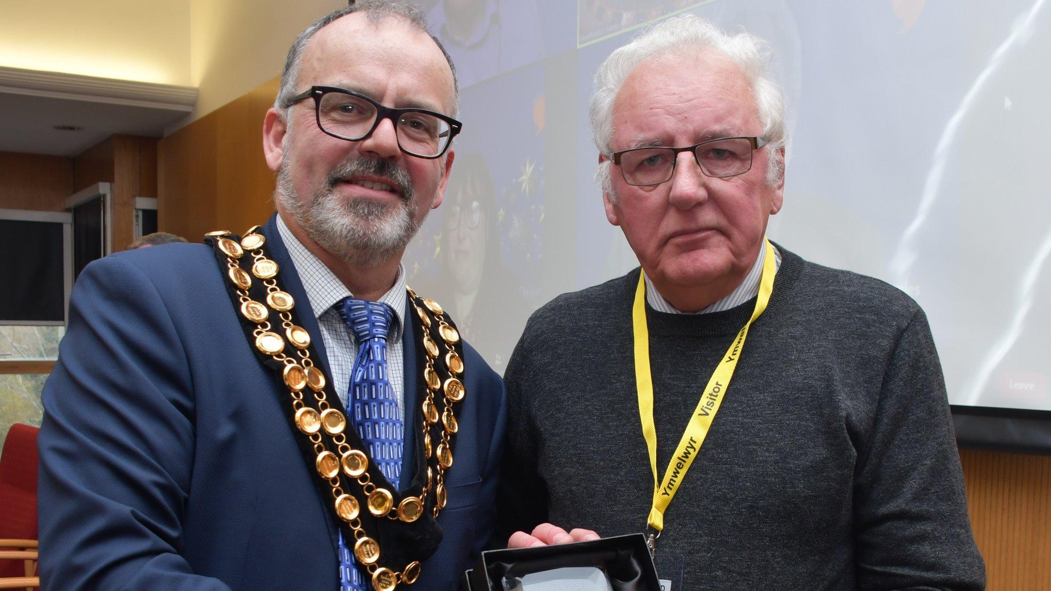 Noel Thomas with the council leader, receiving his honour