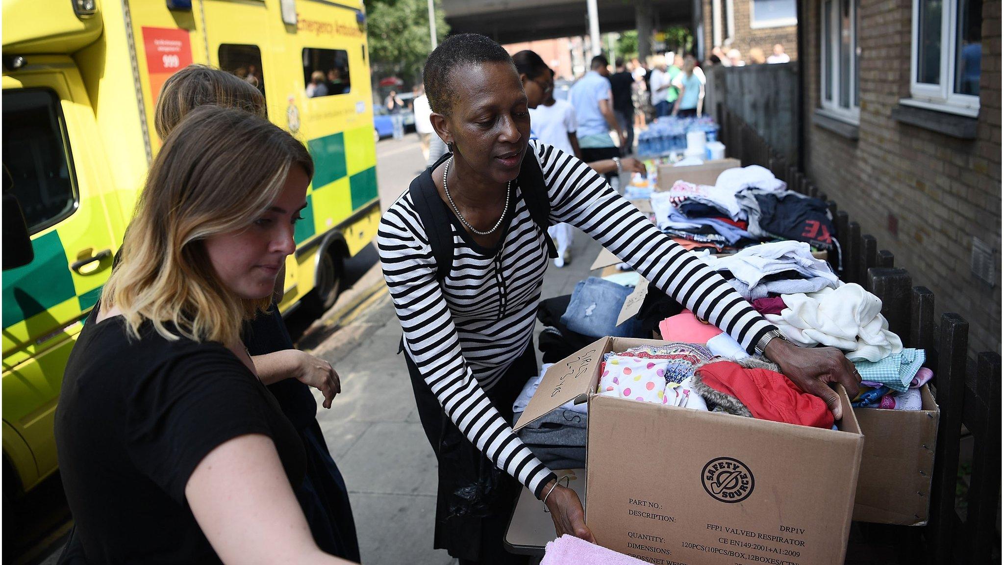 Women carrying donated clothes on 16 June