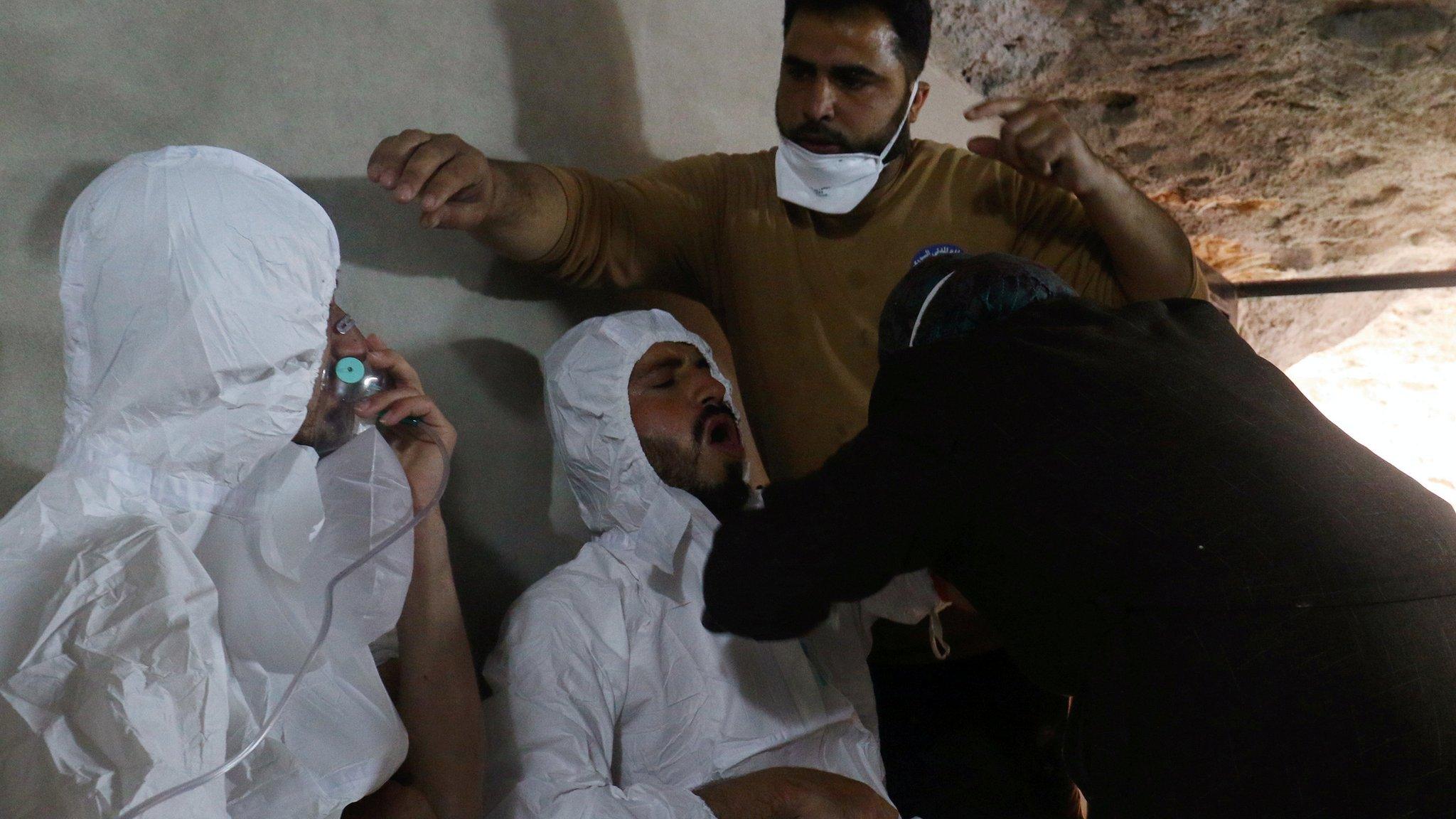 A man breathes through an oxygen mask as another one receives treatments, after what rescue workers described as a suspected gas attack in the town of Khan Sheikhoun in rebel-held Idlib, Syria April 4, 2017.