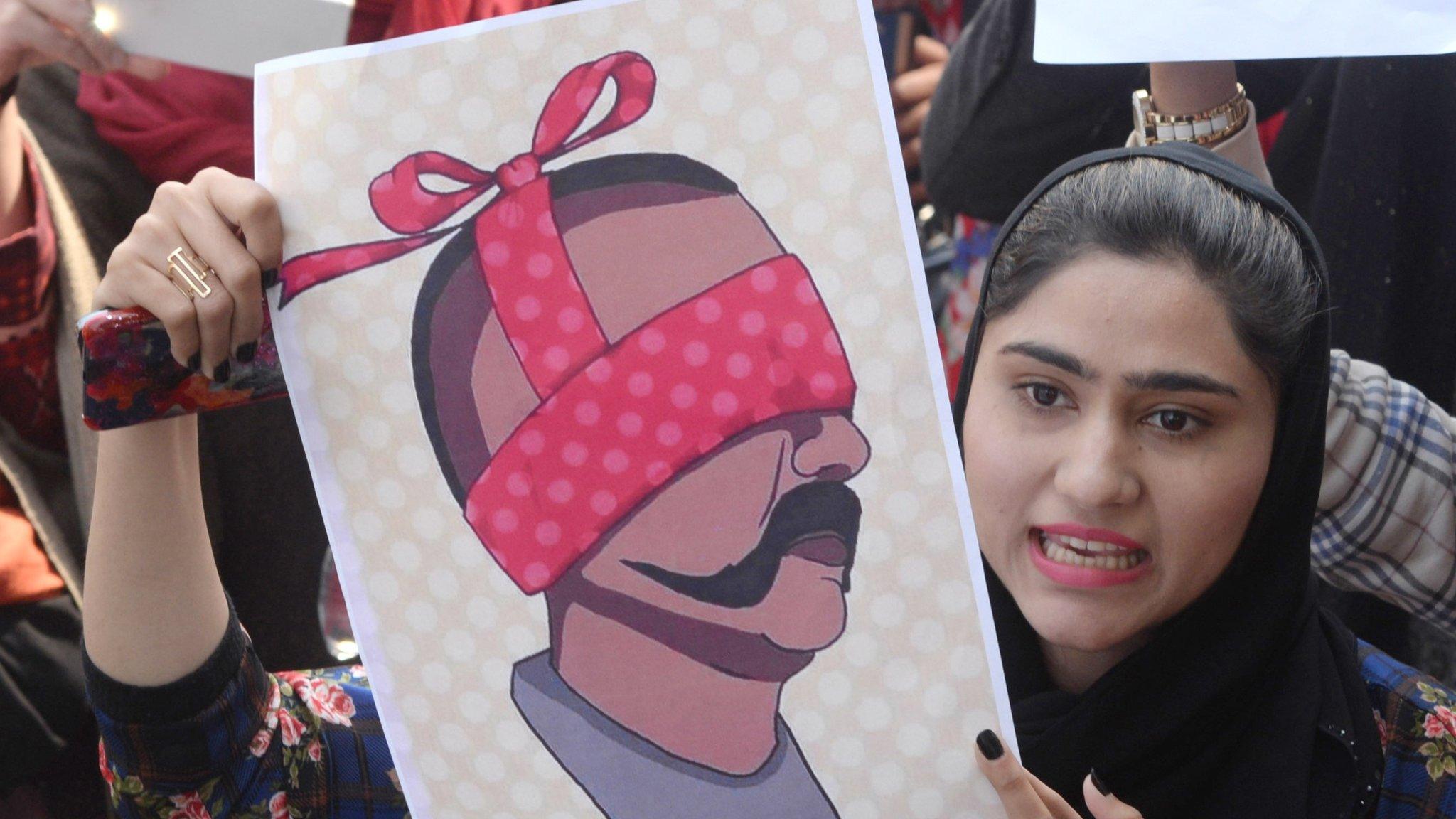 People hold depection of captured Indian Air Force Pilot Wing Commander Abhinandan, as they shout anti-India slogans during a protest in Lahore, Pakistan, 28 February 2019.