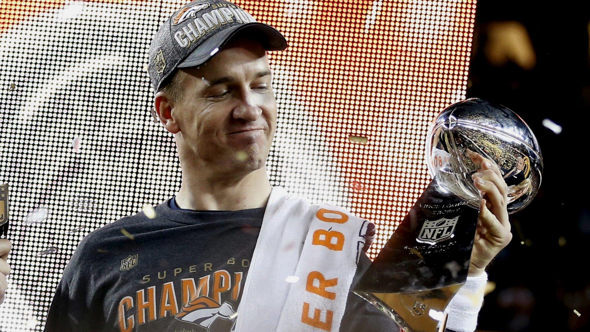 Peyton Manning holds the Vince Lombardi trophy