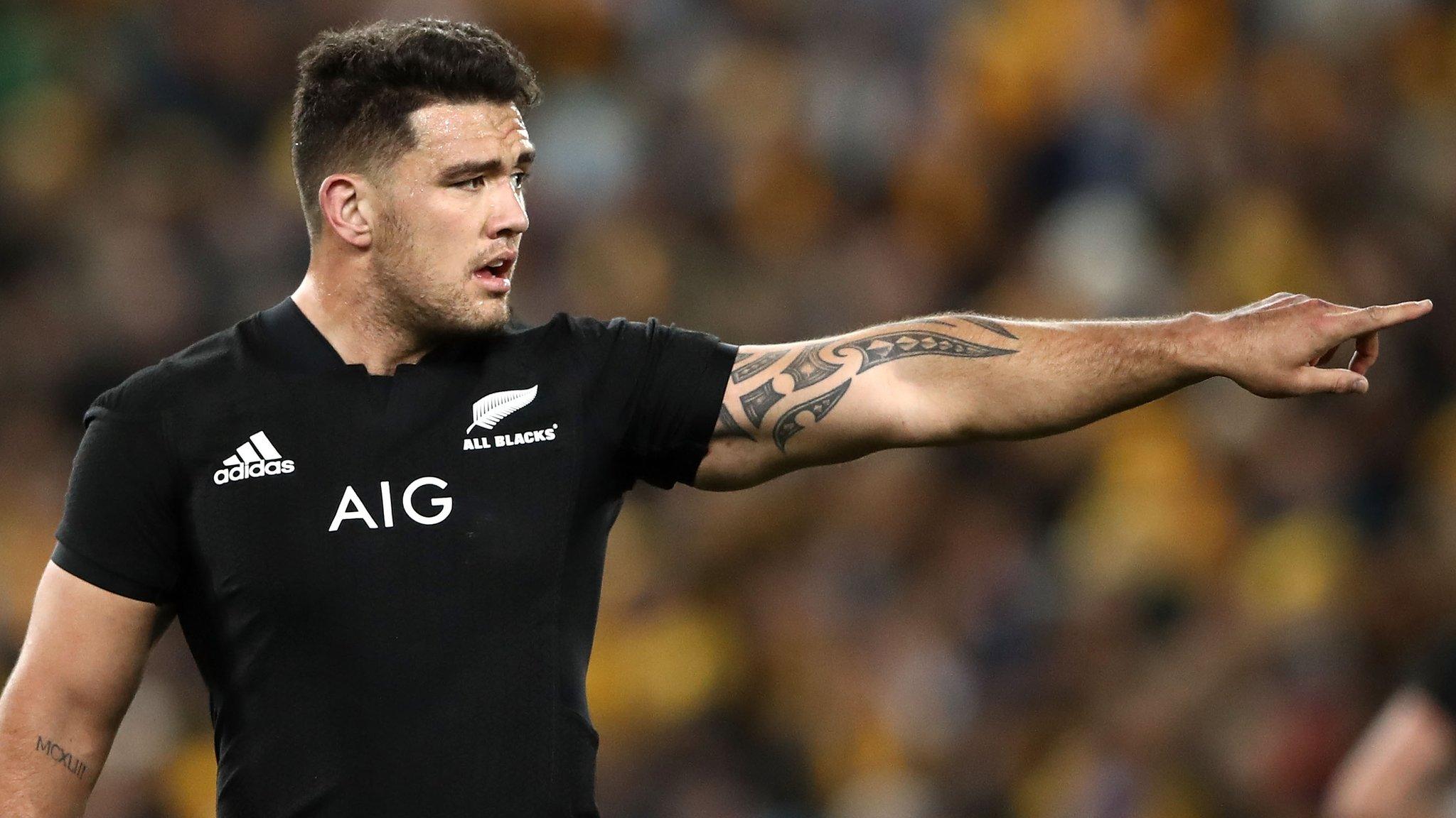 Codie Taylor makes a point to his All Blacks team-mates