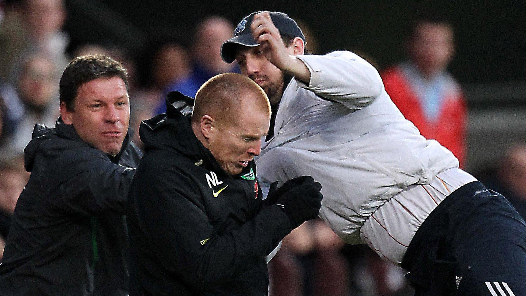 Former Celtic manager Neil Lennon is attacked by a fan at Tynecastle