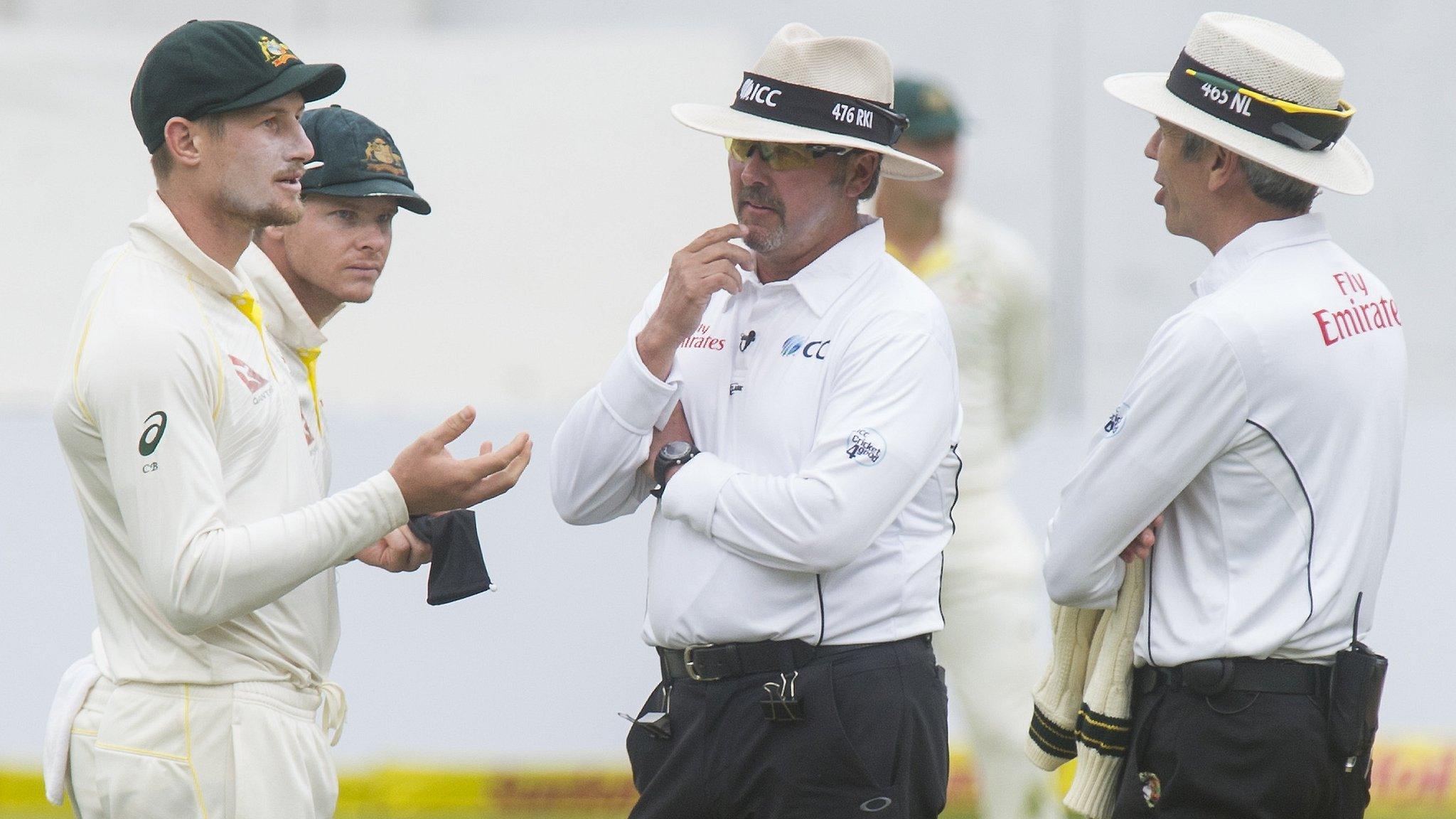 Australia's Cameron Bancroft speaks to umpires Nigel Llong and Richard Illingworth