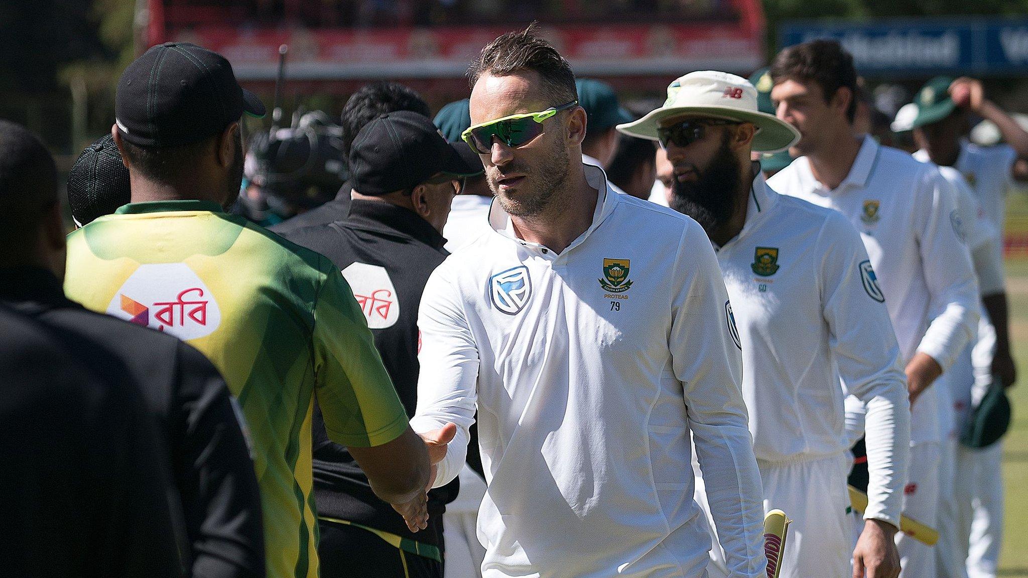 Bangladesh and South Africa's players shake hands after the Test series