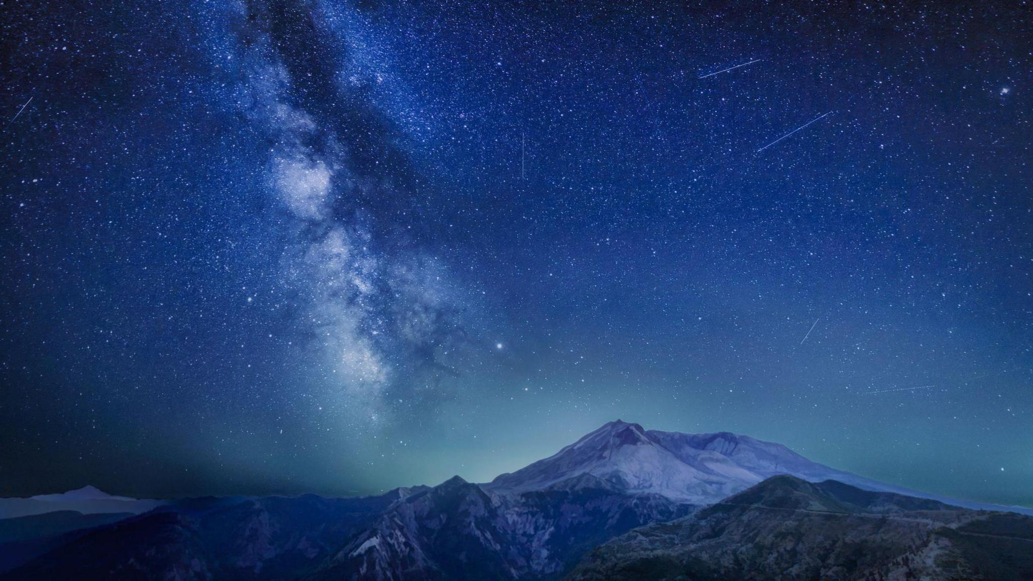 The Delta Aquariids meteor shower and Milky Way over Mount St. Helens, at Windy Ridge in Washington State with Mt. Hood, Oregon v