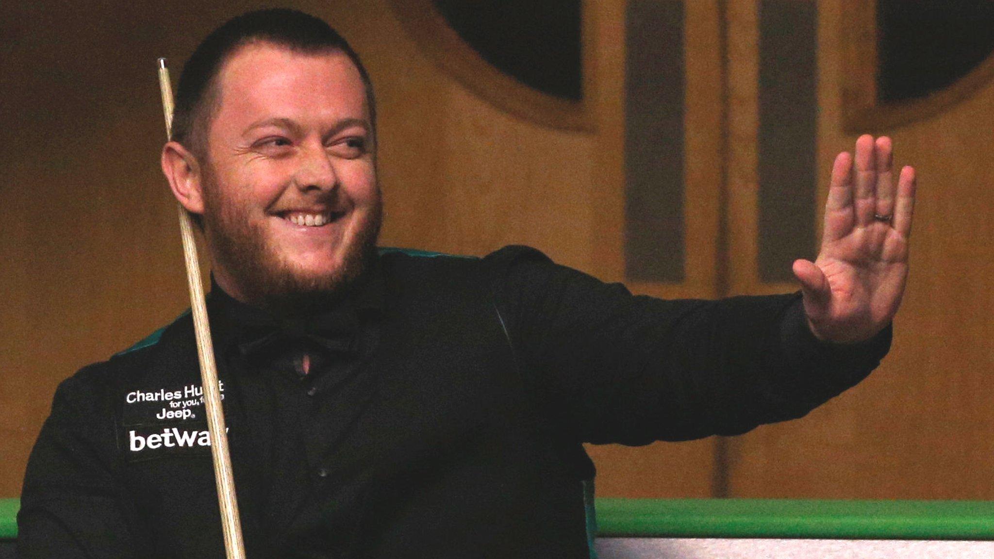 Mark Allen celebrates after hitting the maximum during the second-round encounter