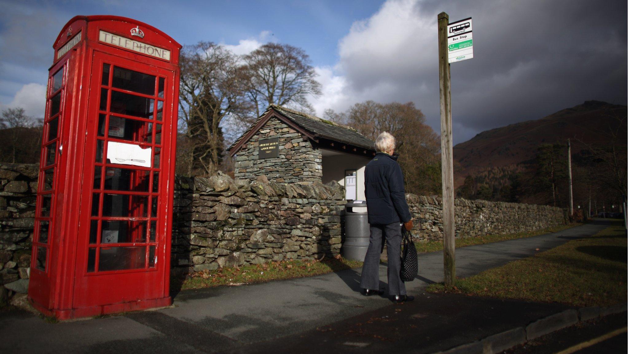 Woman waiting at bus stop in countryside