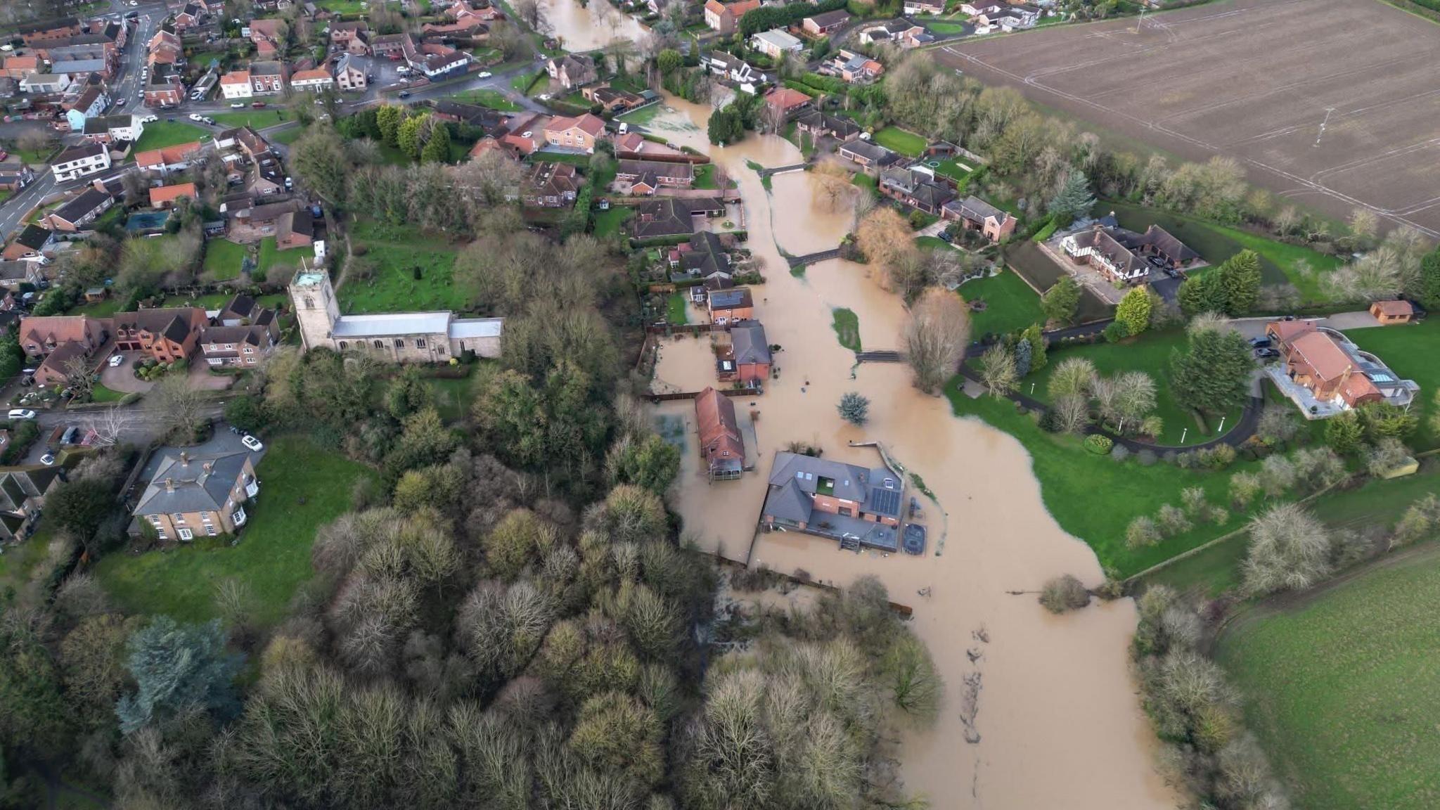 Aerial view of Lindholme in Scotter which was was hit by flooding from the River Eau in January brown water surrounds a number of houses