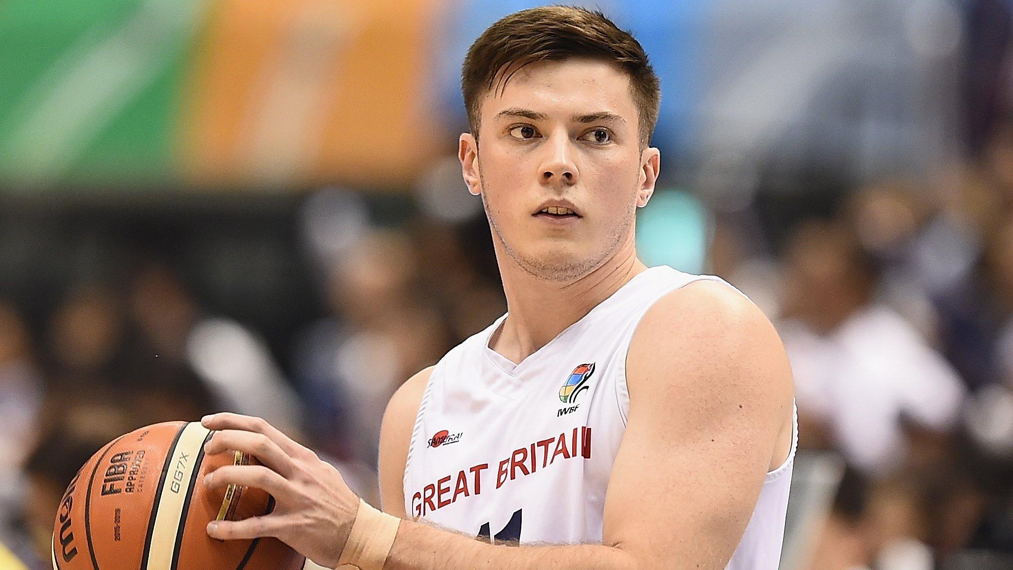 Phil Pratt holds a basketball