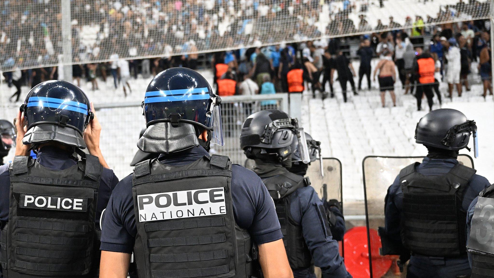 Police approach fans in stand