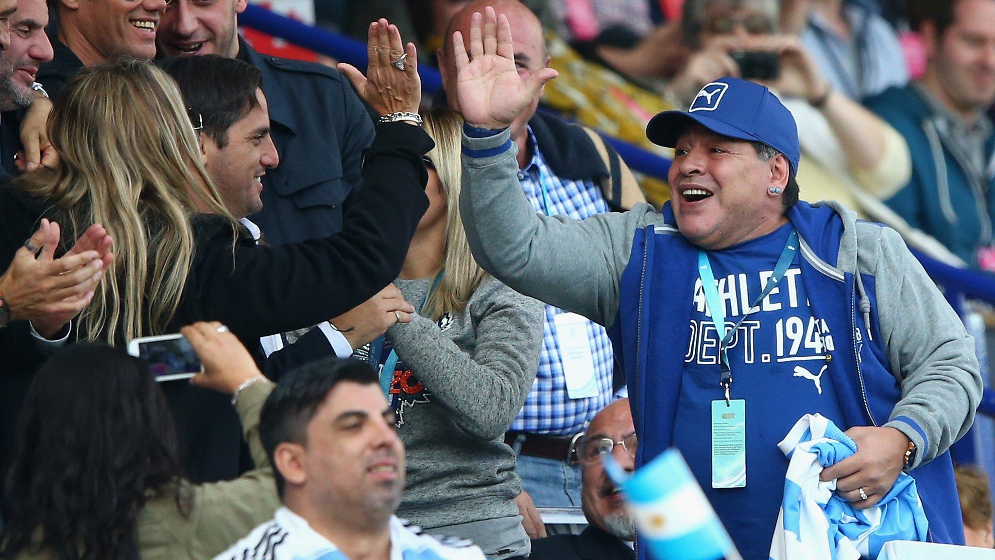 Maradona celebrates an Argentina try with former Argentina rugby captain Agustin Pichot