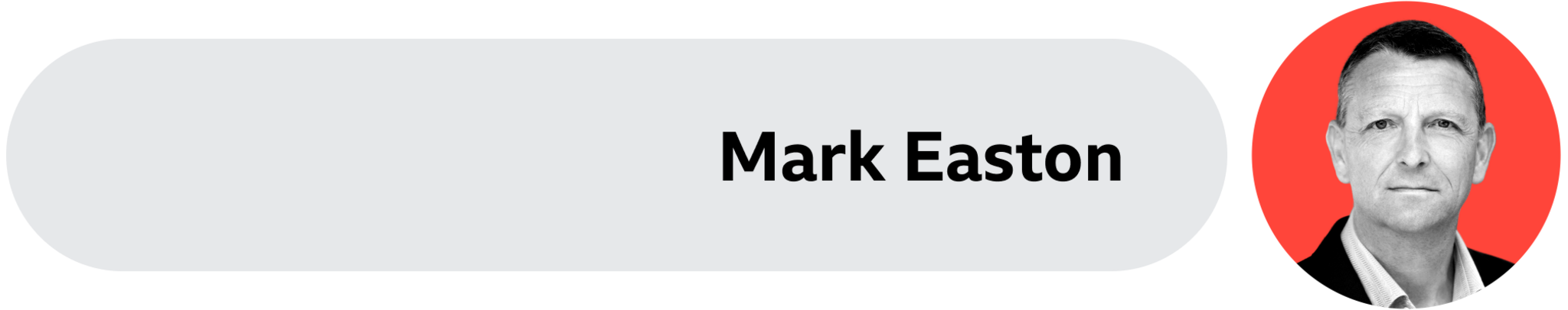 A grey box with Mark Easton's name written on it. His face is on the right side. 
