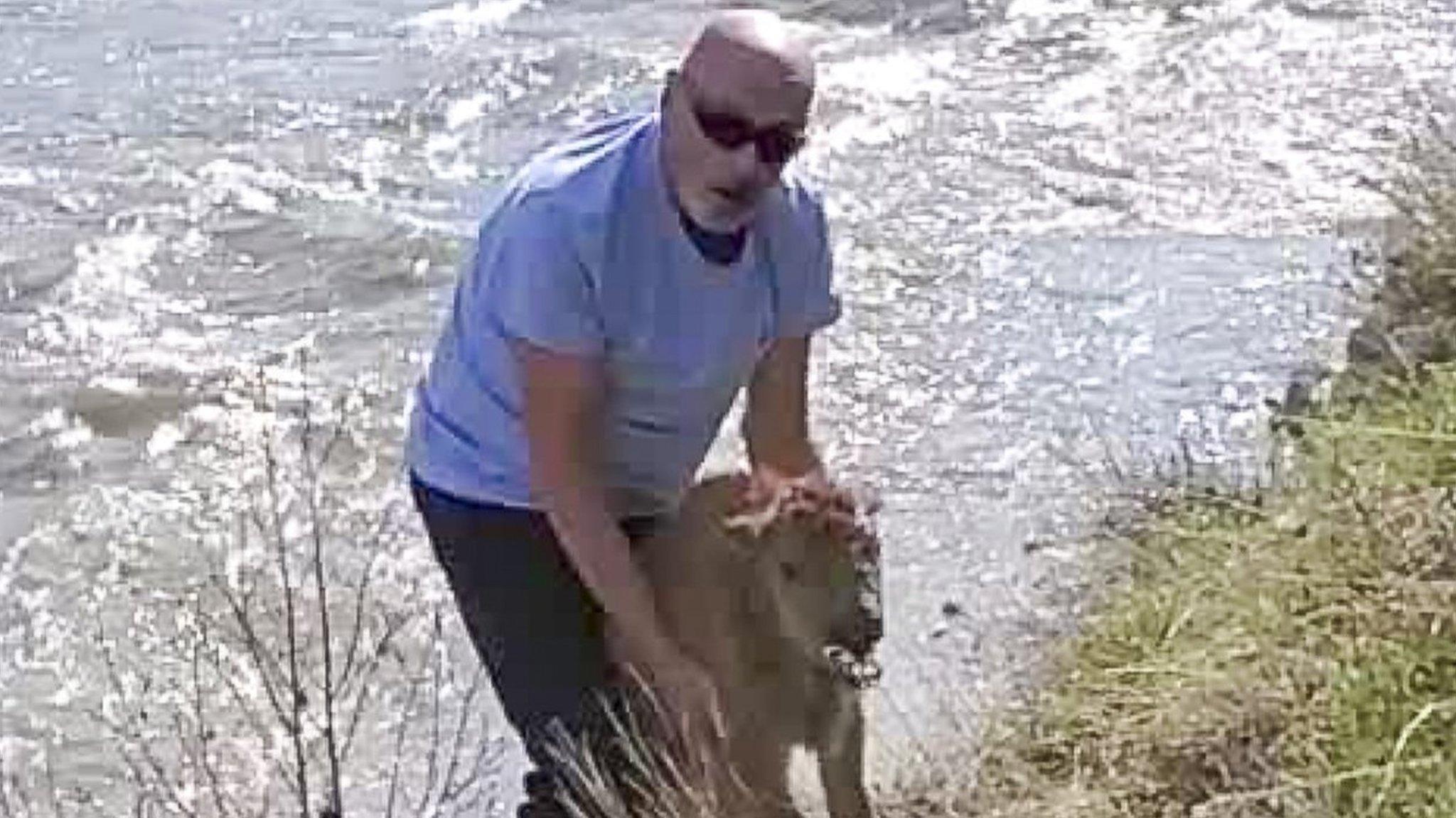 Photo of the unidentified man holding the bison calf