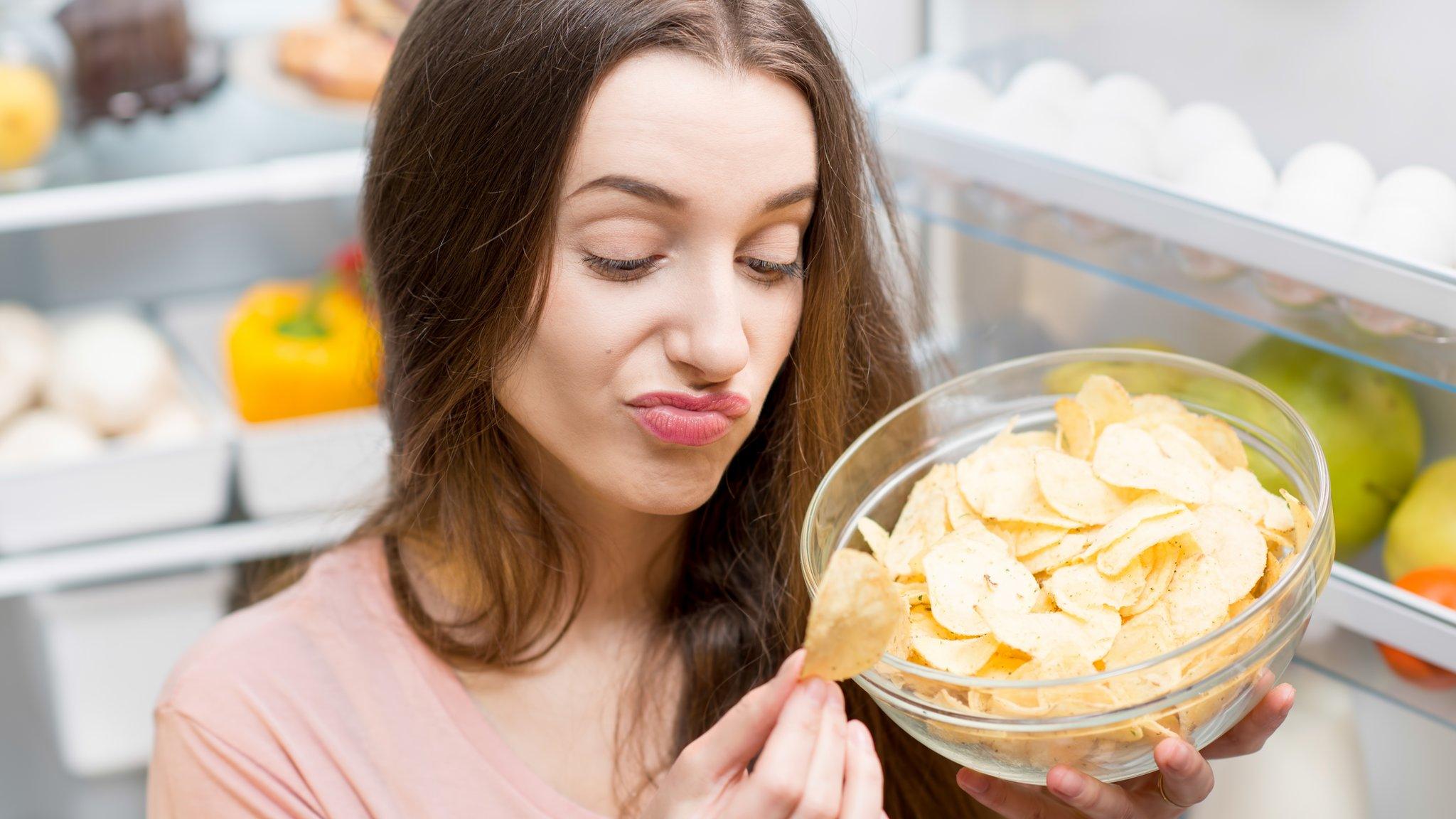 Young woman looking at a crisp