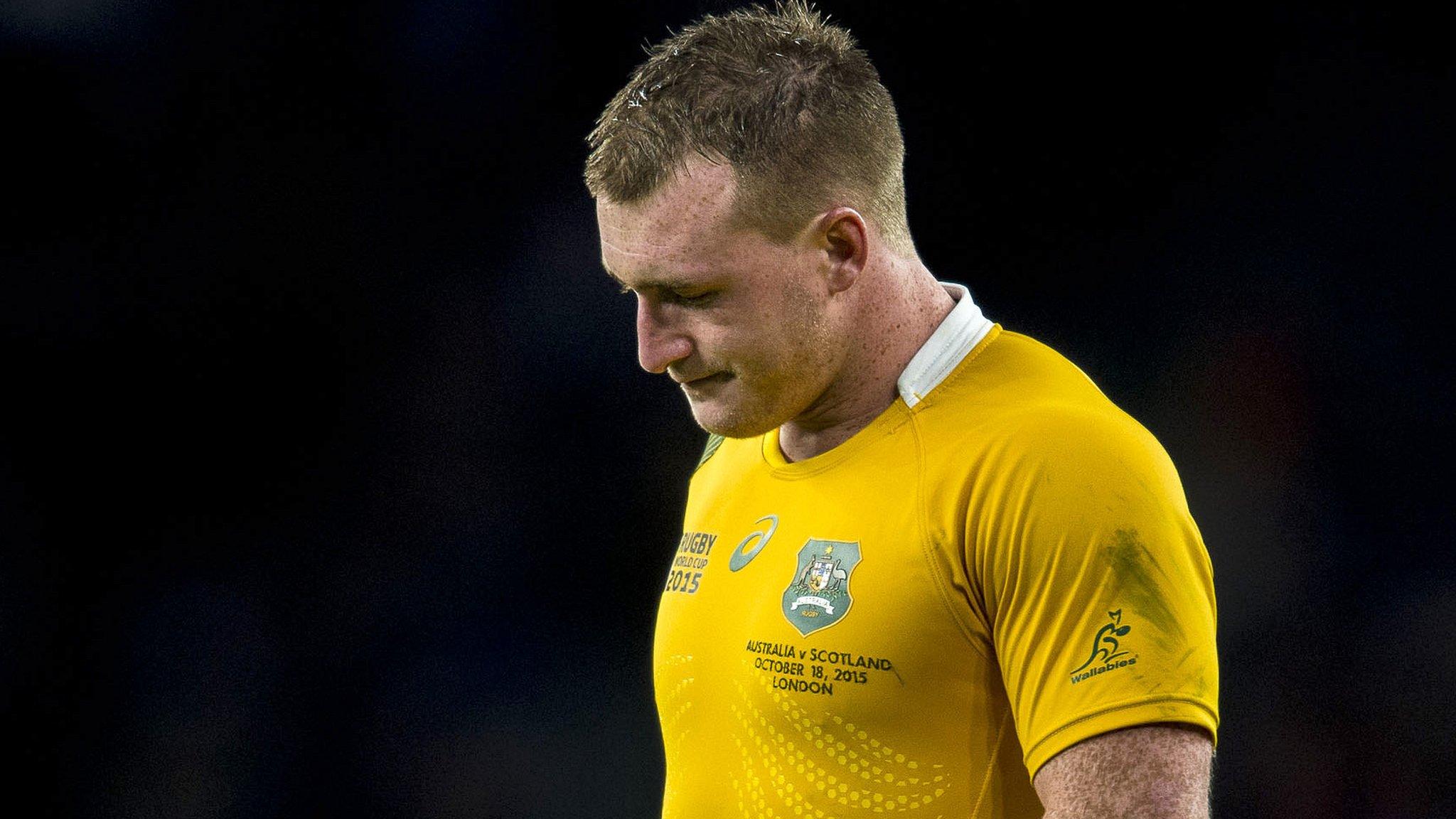 Stuart Hogg, wearing an Australia shirt, looks downcast after Scotland's World Cup quarter-final defeat