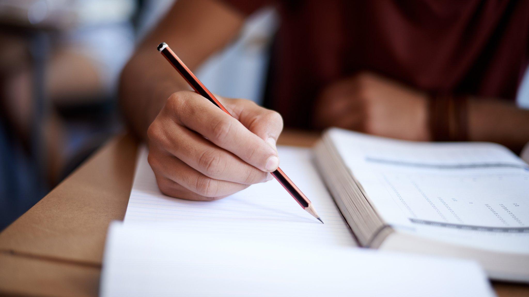 Photo of boy doing exam paper