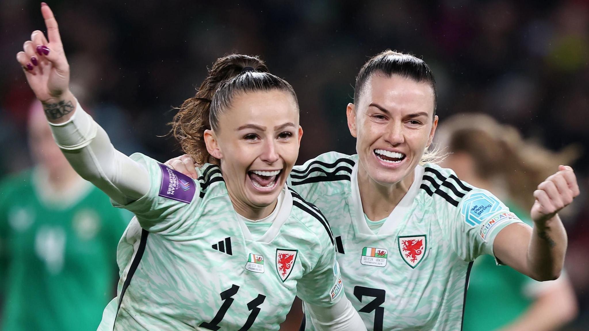 Wales' Hannah Cain celebrates after scoring the opening goal from a penalty with team-mate Gemma Evans