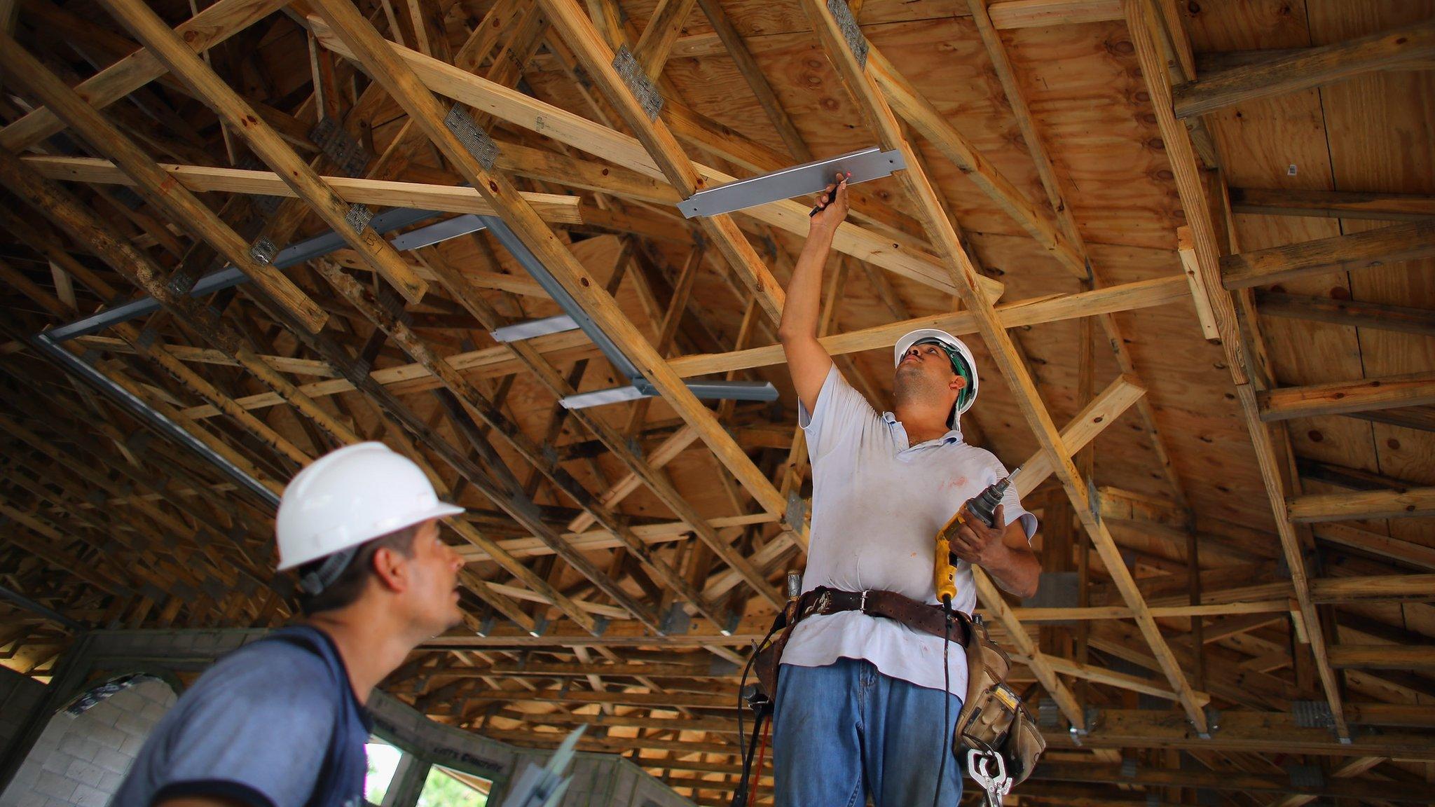 Construction workers, Louis Delgado (L) and Tony Rodriguez work on building a Toll Brothers Inc. home on September 26, 2012 in Boca Raton, Florida