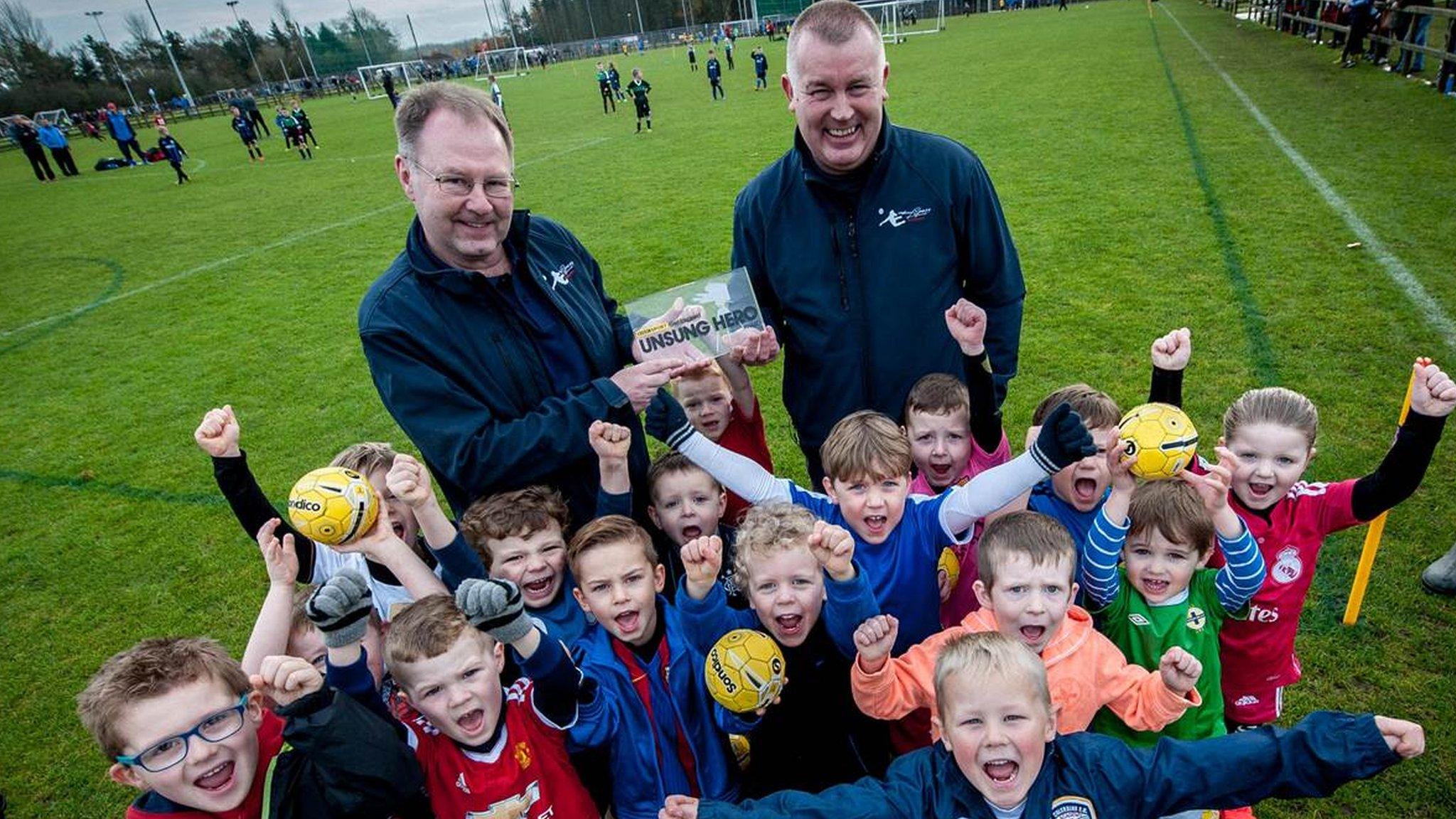 Harry Gregg Foundation trustee James Dooley presents the 2016 Unsung Hero award to Andy Alcorn