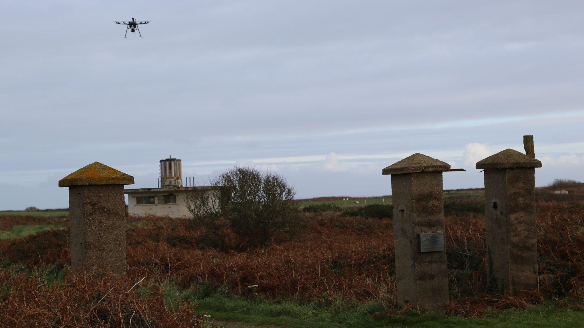 A survey drone over the remains of the main gates of the concentration camp