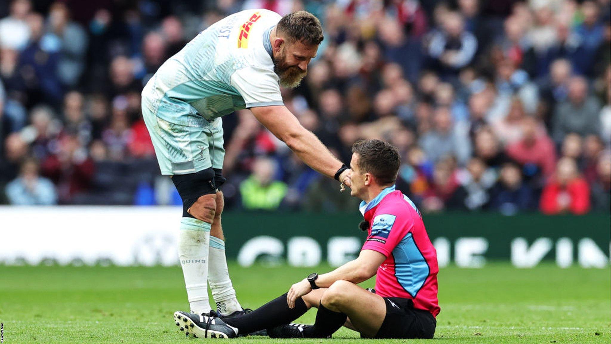 Irne Herbst helps referee Luke Pearce after their accidental collision