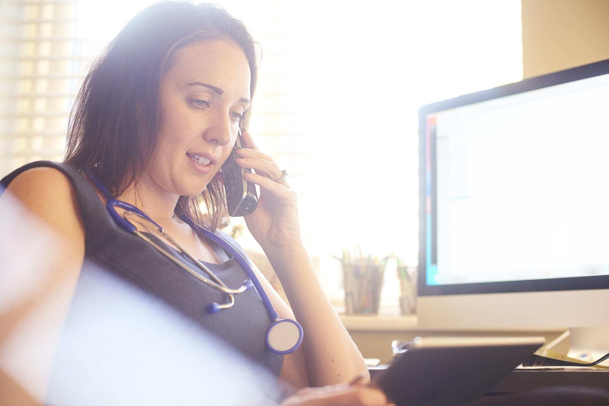 Female doctor talking on phone