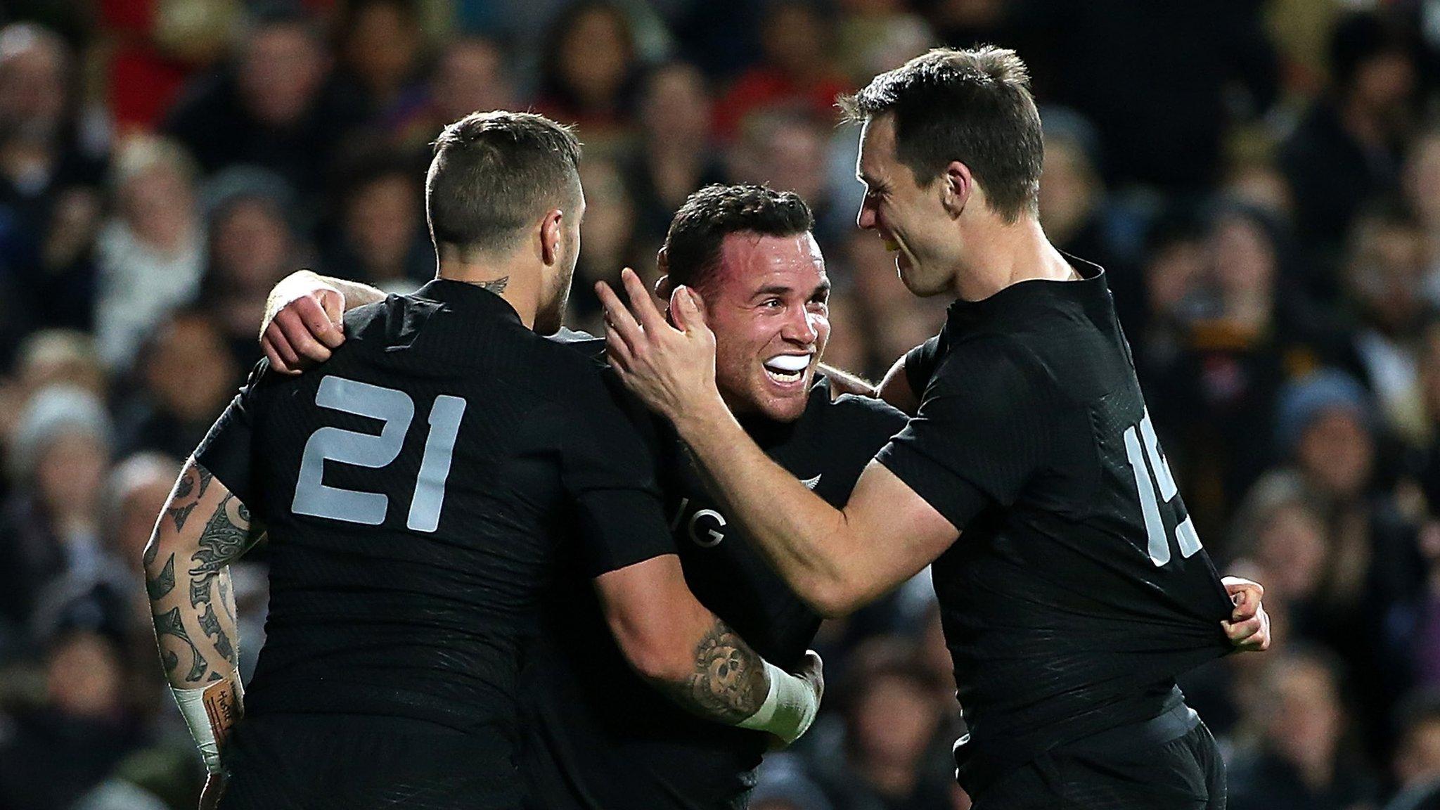 Beauden Barrett (centre) celebrates a try against Argentina