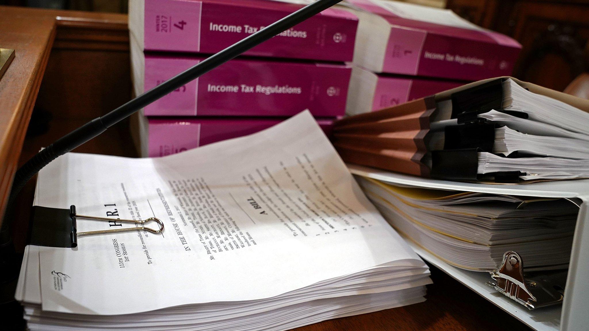 Legislation and regulation books are stacked and ready in the House Ways and Means Committee hearing room ahead of a markup session of the proposed GOP tax reform bill in the Longworth House Office Building on Capitol Hill November 6, 2017 in Washington, DC.