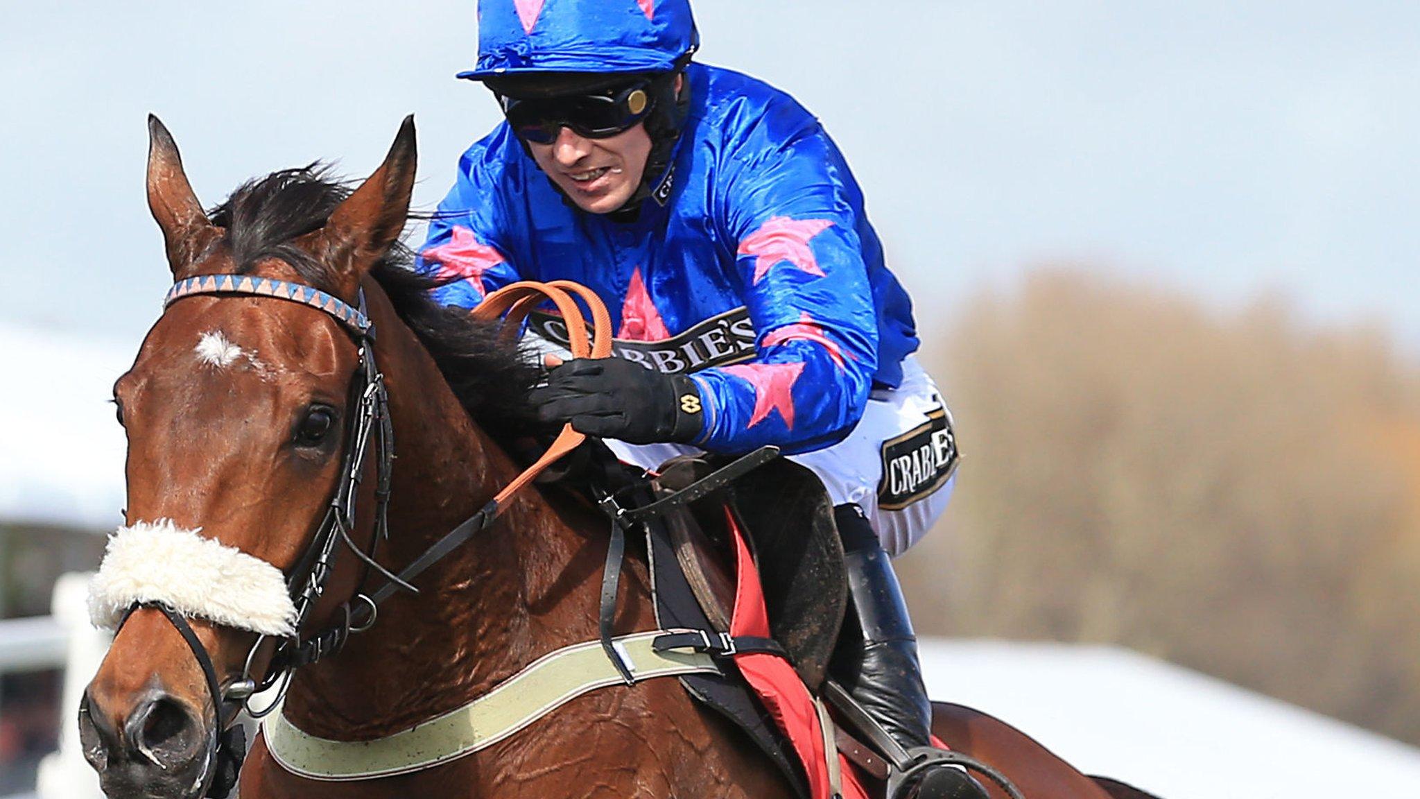 Paddy Brennan riding Cue Card to victory in the Betfred Bowl Steeple Chase at Aintree