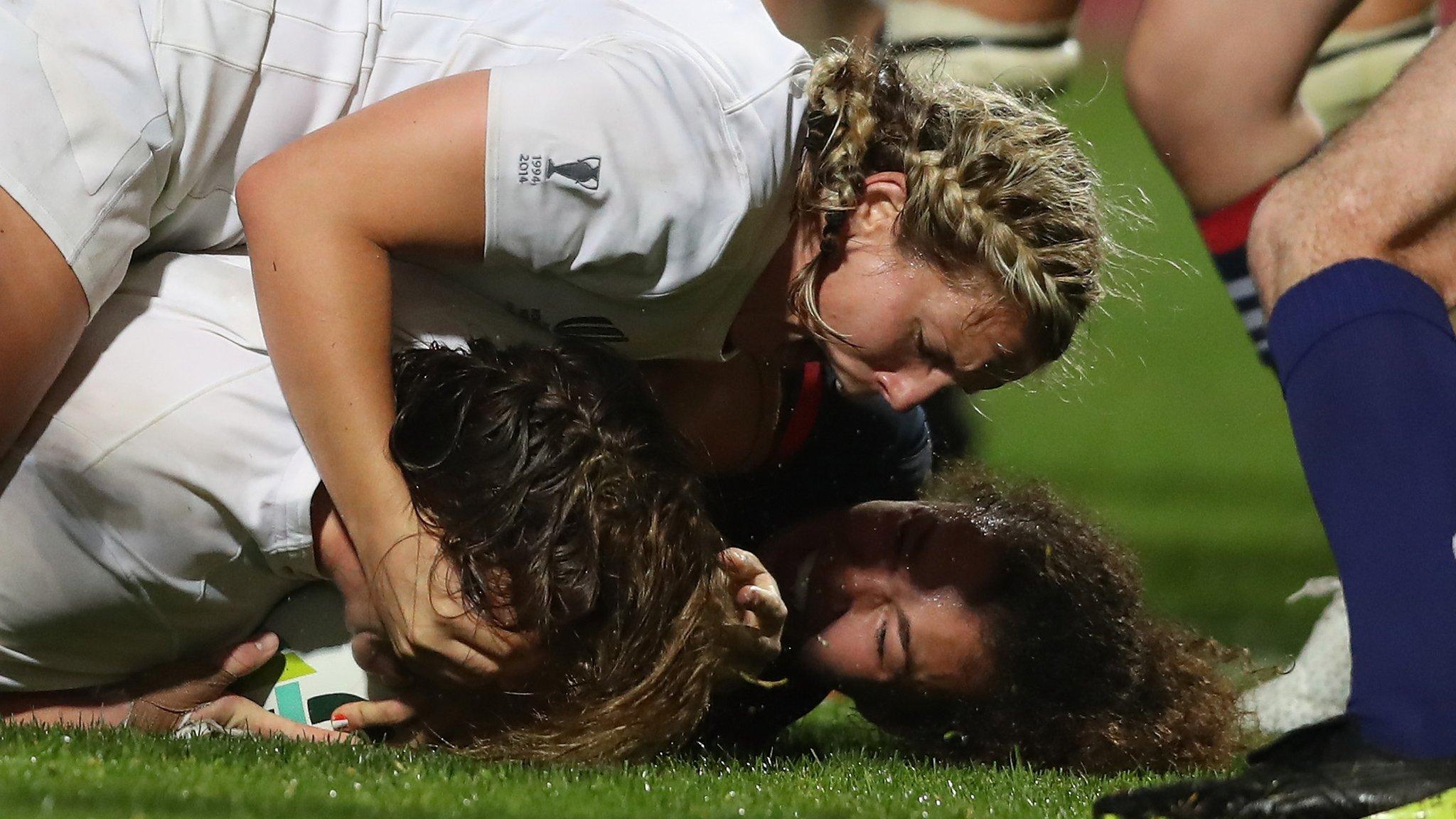 Sarah Bern of England crashes over the line to score