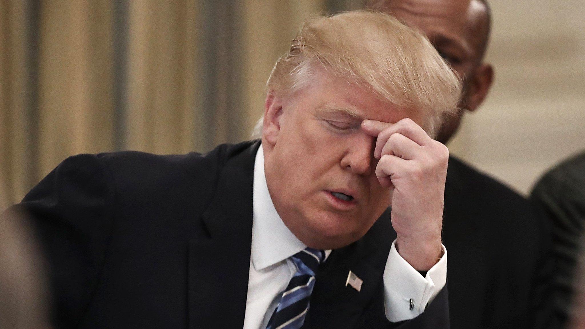 Trump touches his nose