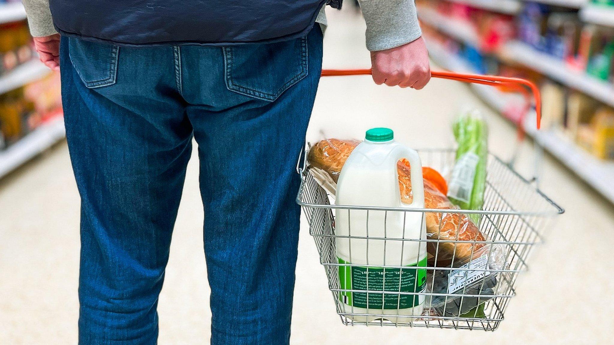 Man holding basket with milk bottle