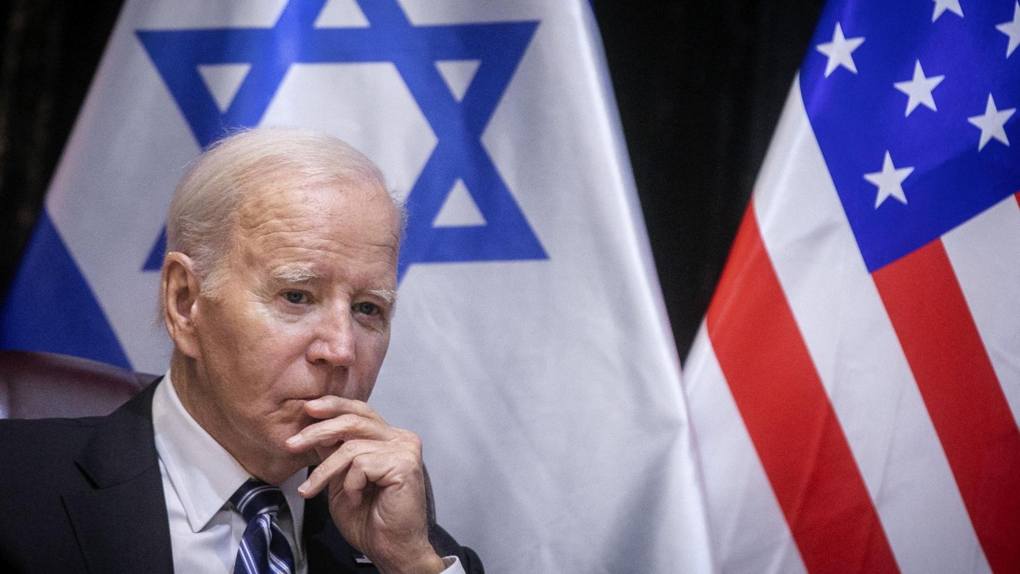 Joe Biden with Israel and American flag behind him