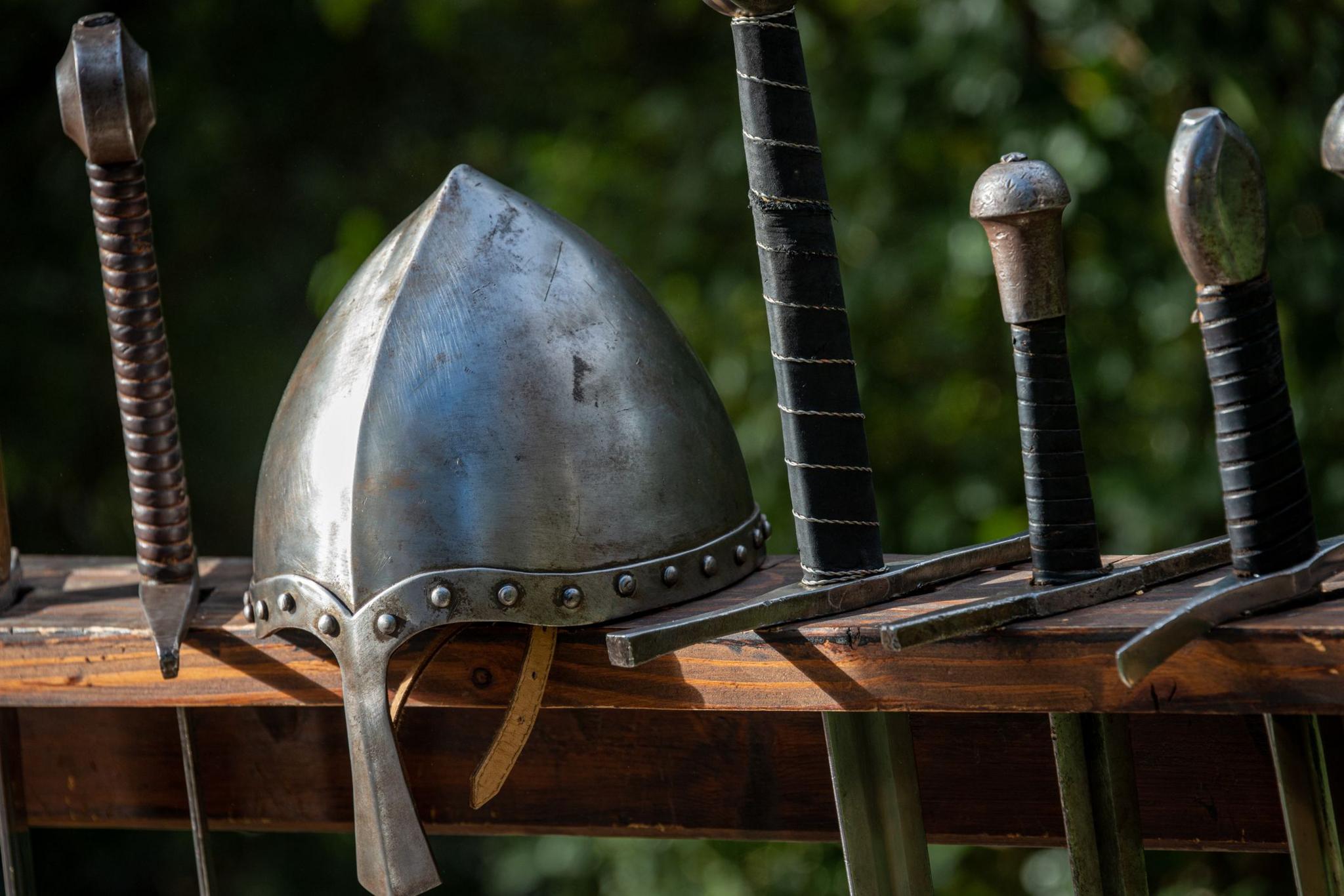 Helmet from a suit of armour and swords