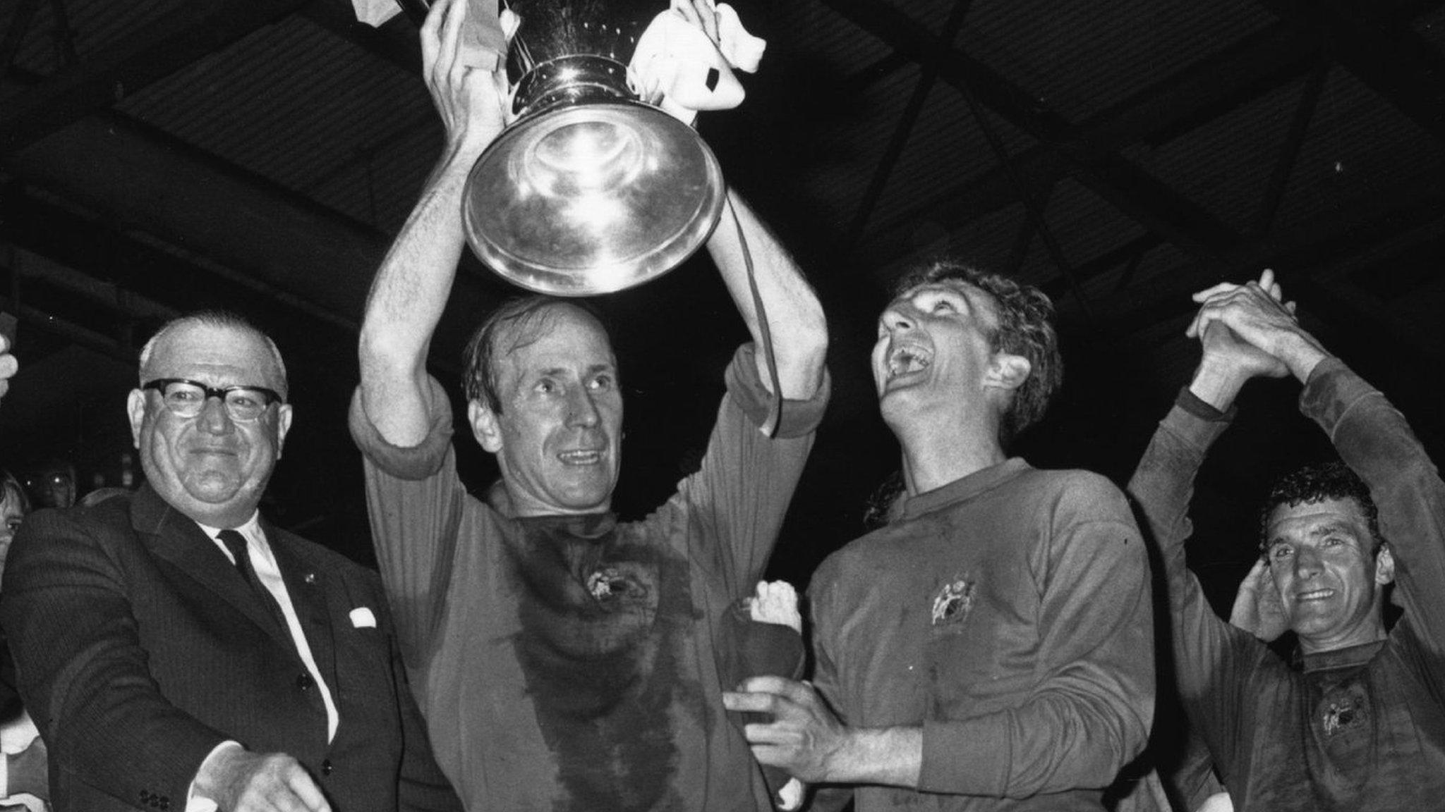 Manchester United captain Bobby Charlton holds the European Cup aloft