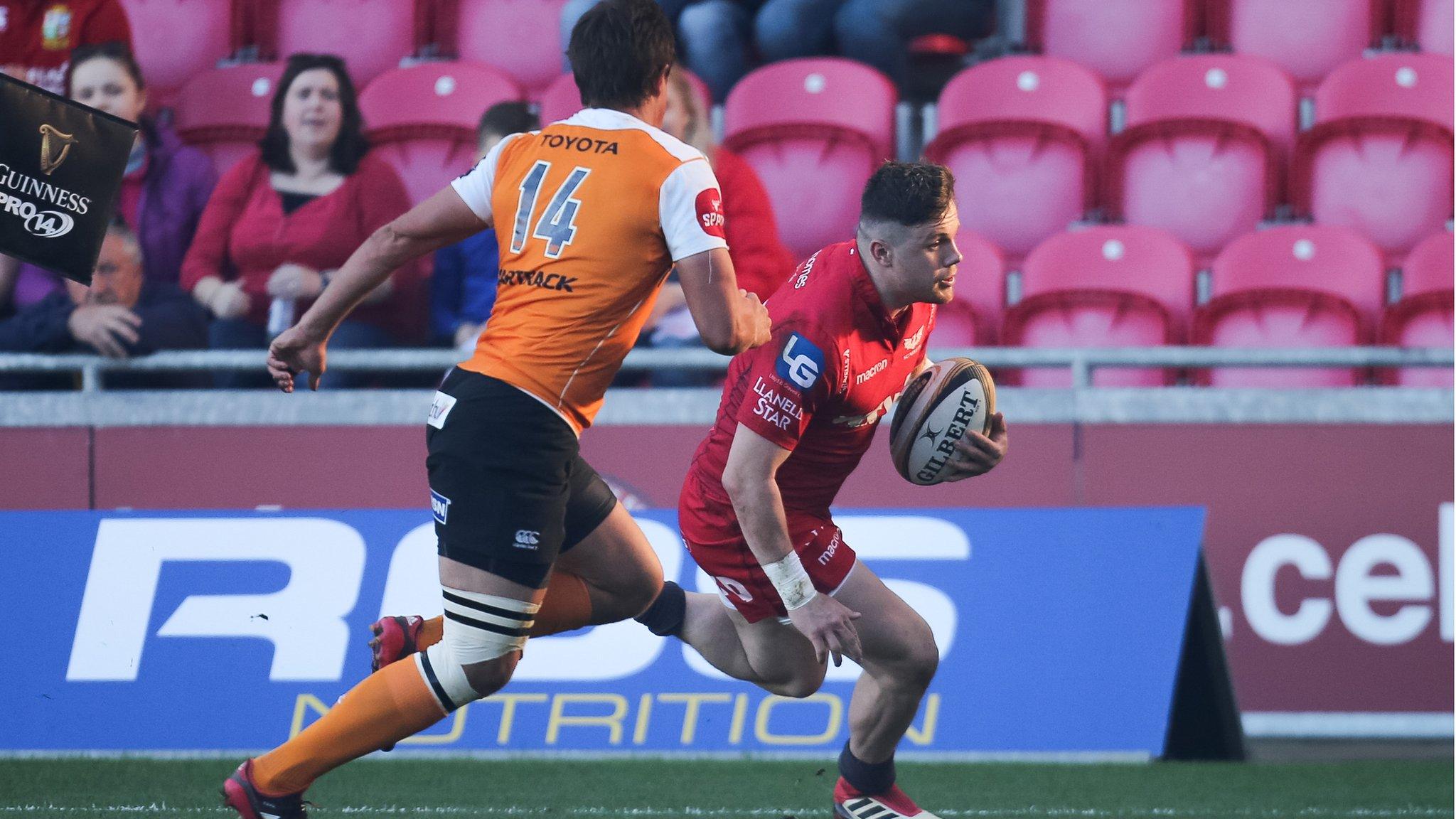 Scarlets wing Steff Evans runs in the first of his tries