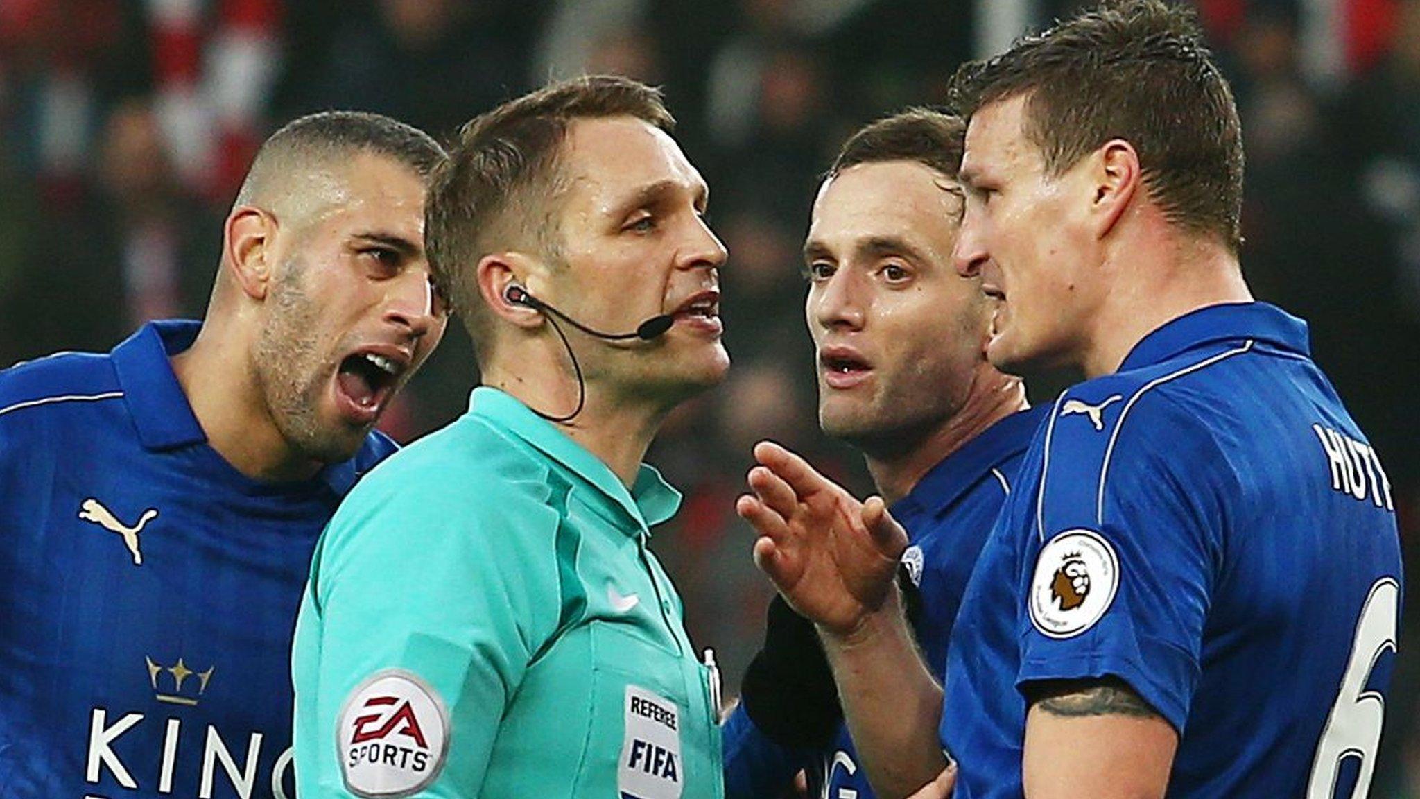 Leicester players surround the referee