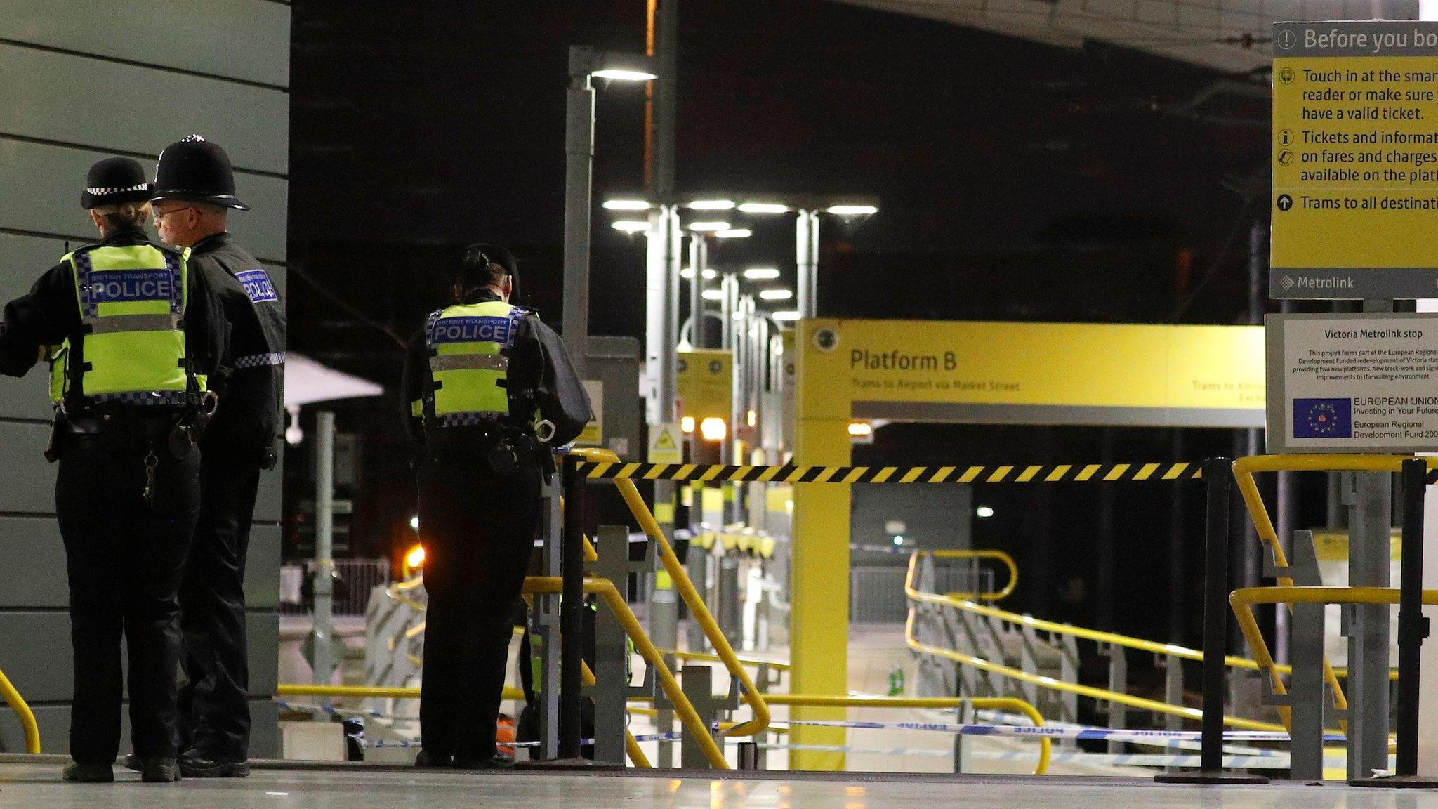 Officers by a tram platform at the station