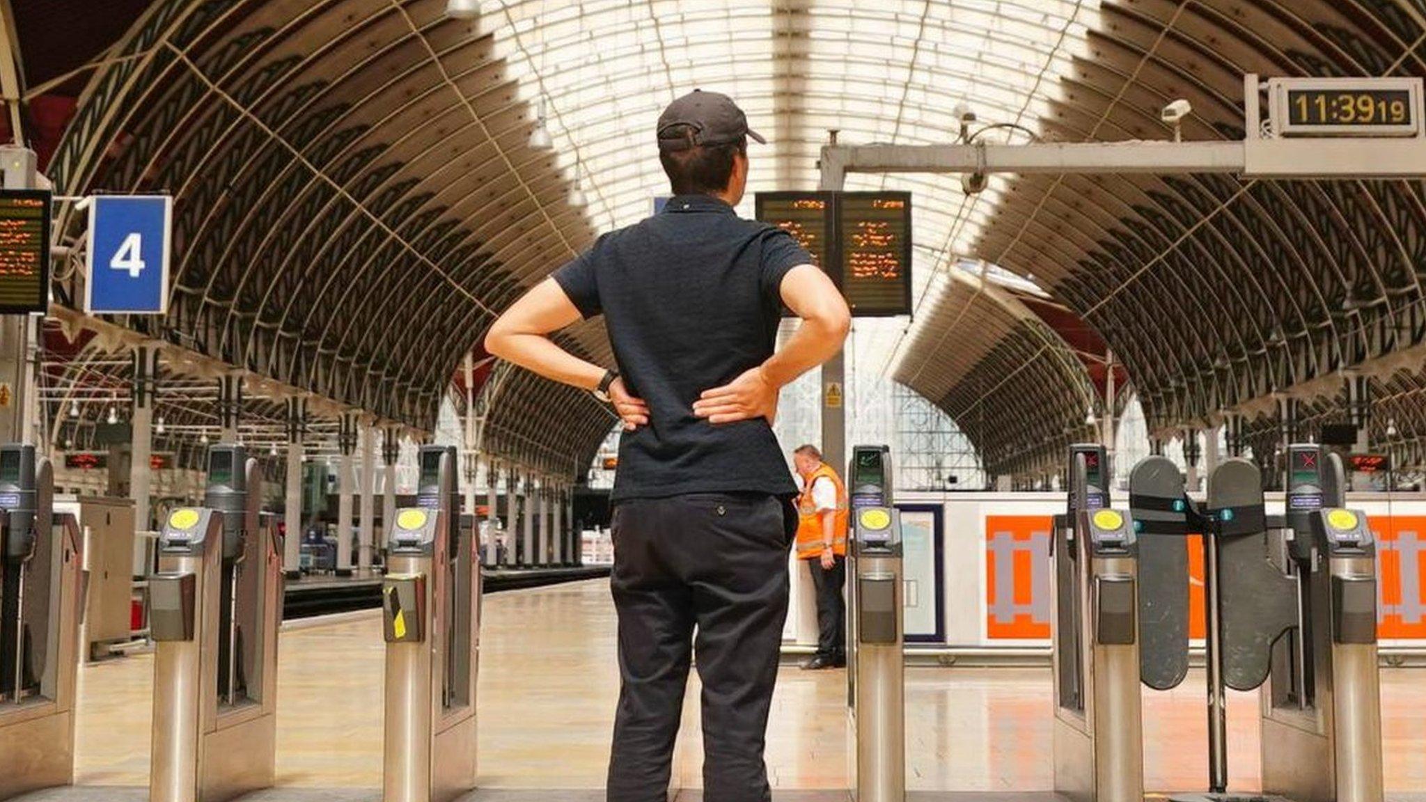 A man looks at boards showing cancellations last month