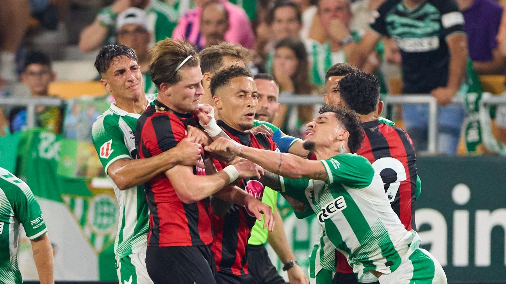 Antony of Real Betis fights with Alex Scott of AFC Bournemouth during the pre-season friendly