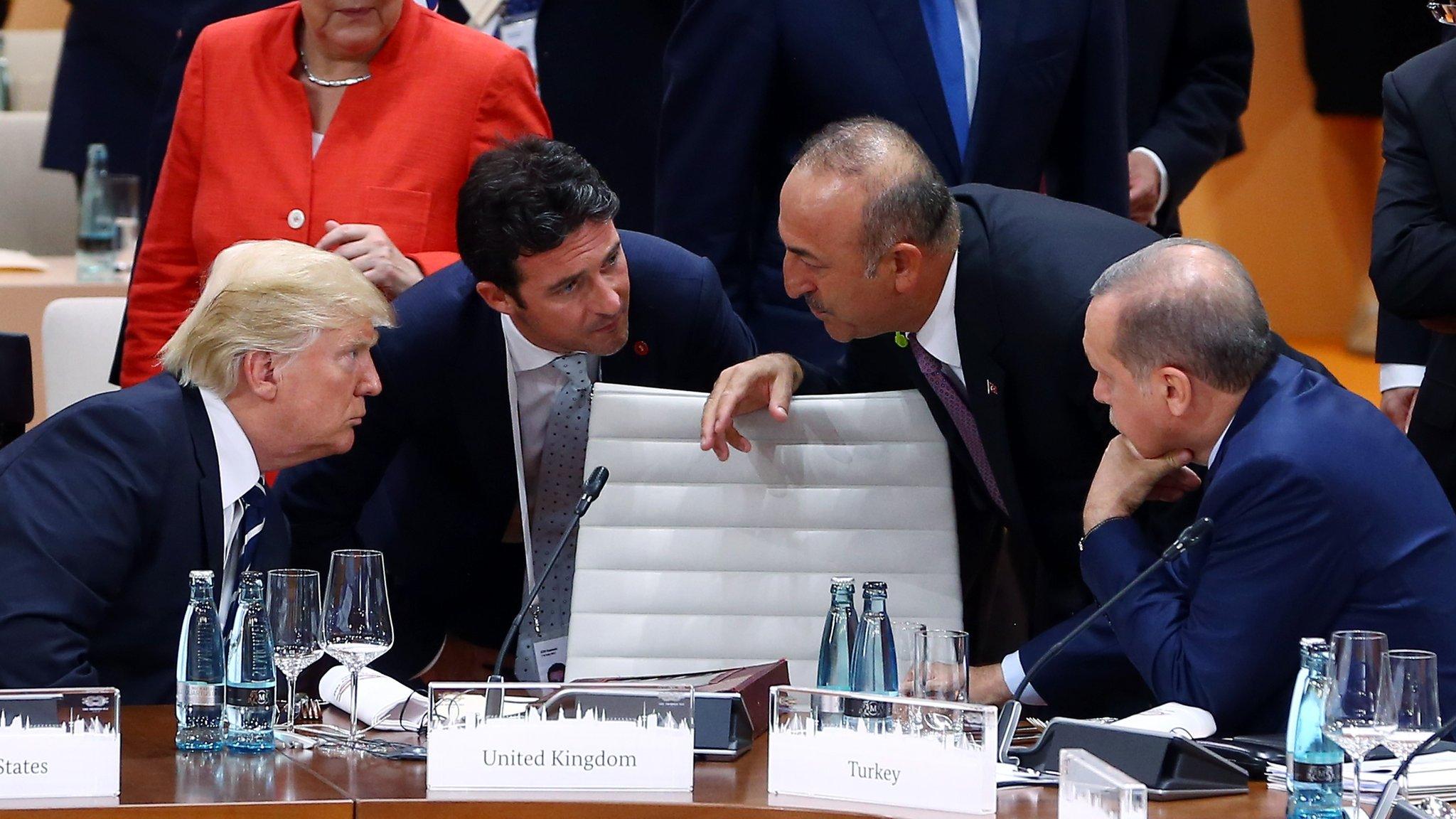 AMBURG, GERMANY - JULY 07: President of Turkey Recep Tayyip Erdogan (R) talks with US President Donald Trump (L), accompanied by Foreign Affairs Minister of Turkey Mevlut Cavusoglu (2nd R), during a session within the G20 Leaders' Summit in Hamburg, Germany on July 07, 2017. (Photo by Kayhan Ozer/Anadolu Agency/Getty Images)