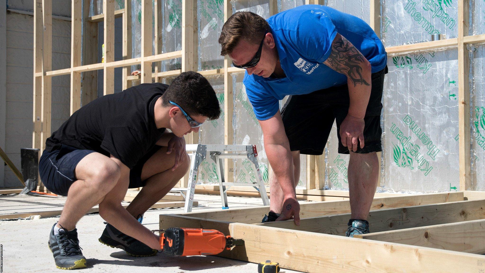 Alan Dalton (right) overseeing a volunteer at Croydon Football Club