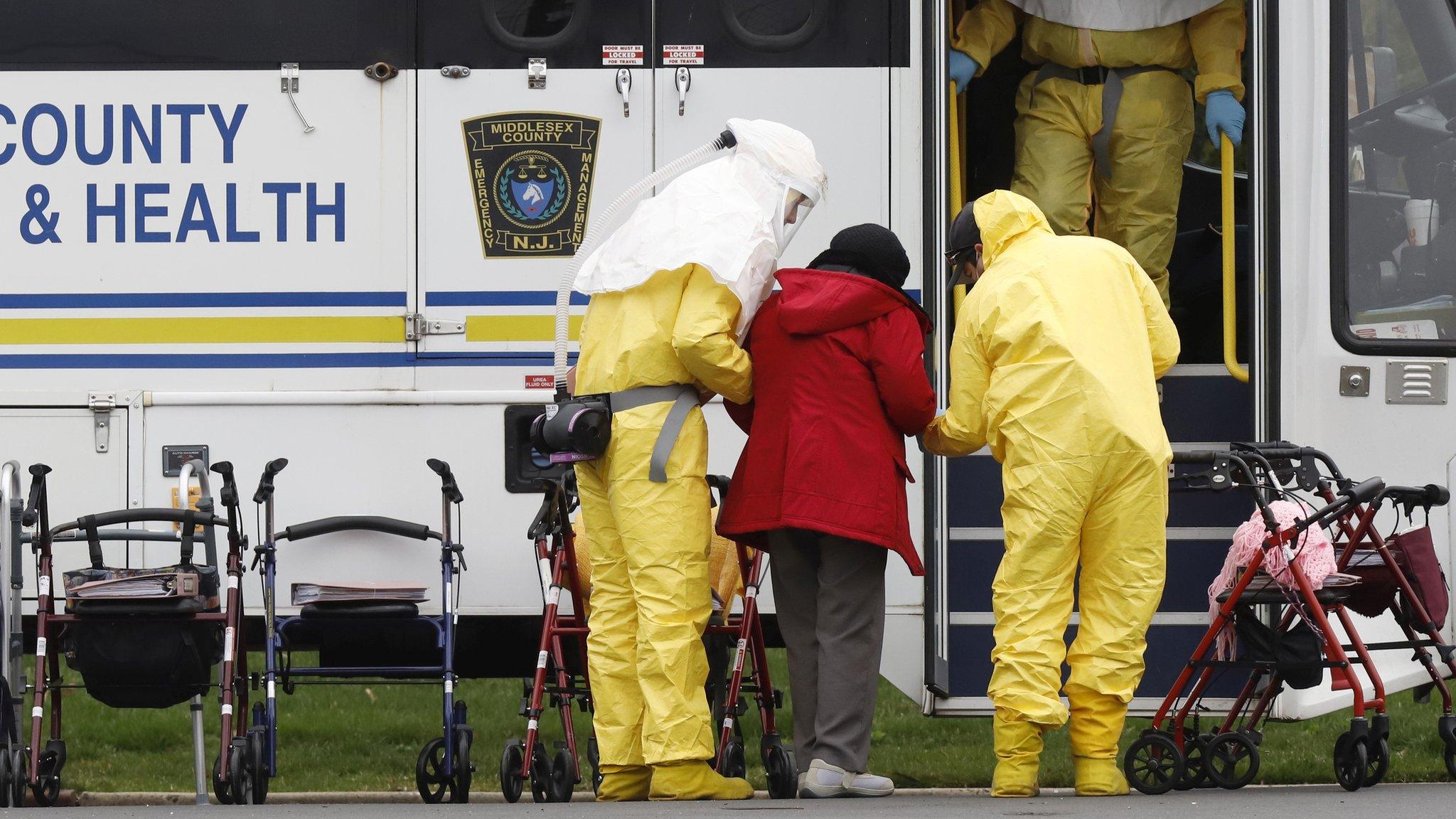 Medical officials in the US assist a care home resident