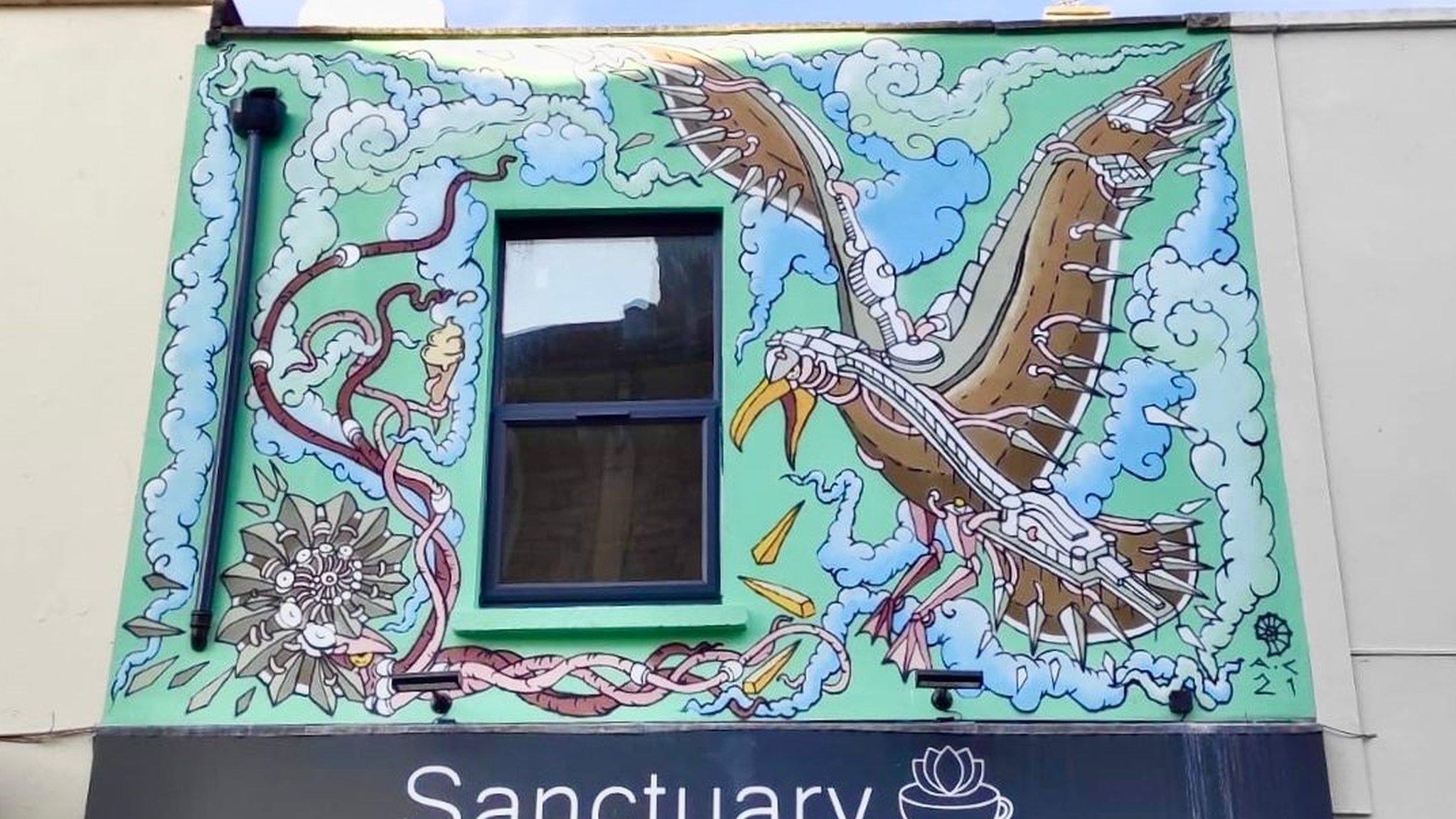 Bird mural featured on a coffee shop building