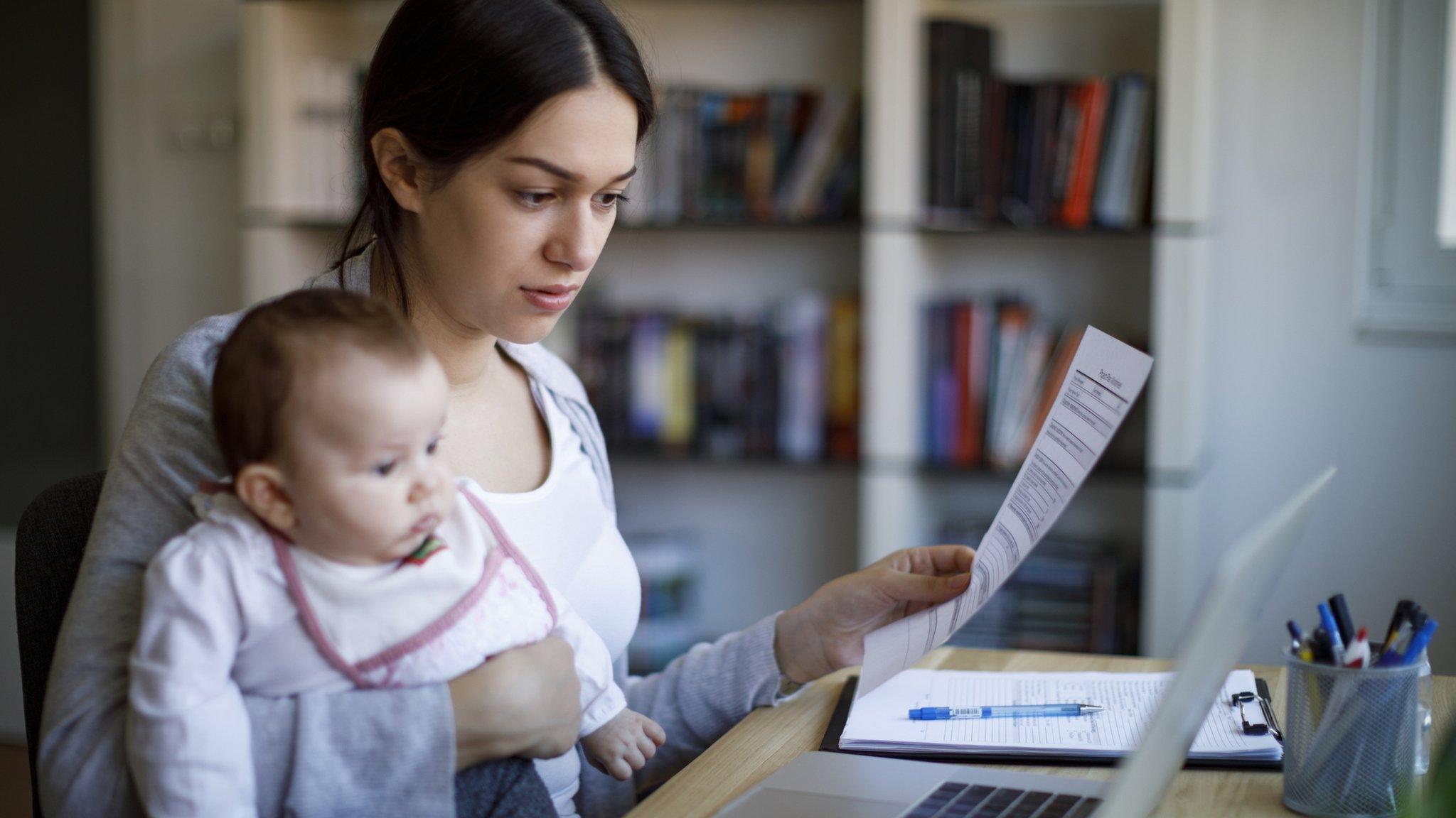 Mother with baby at laptop