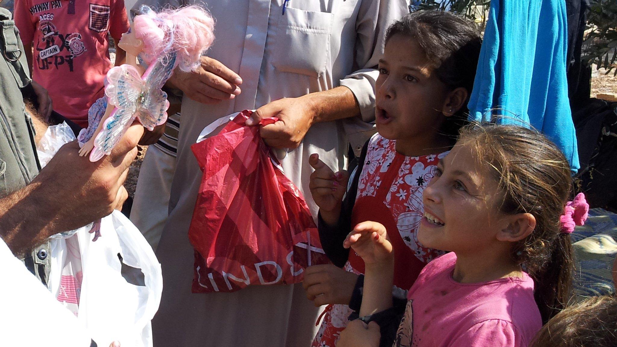 Syrian girls receiving toys