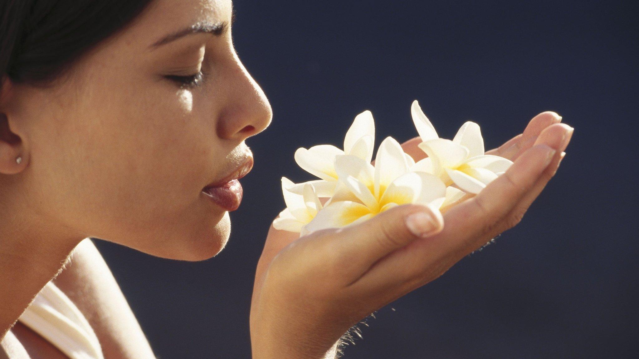 woman smelling flowers