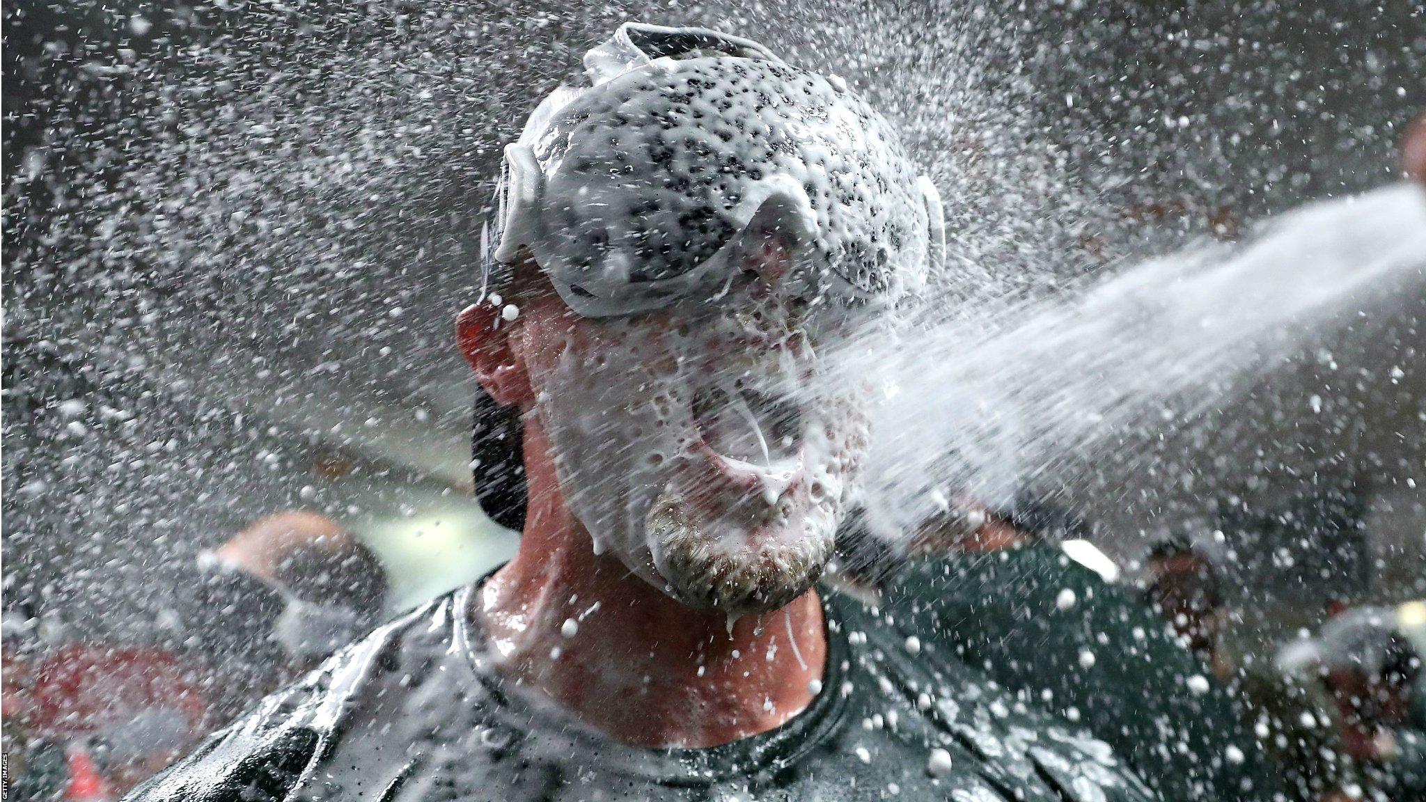 Seattle, United States, 24 September: Jed Lowrie is covered in champagne as his Oakland Athletics side celebrate clinching a spot in the Major League Baseball play-offs following their victory over the Seattle Mariners at Safeco Field. (Photo by Abbie Parr/Getty Images)