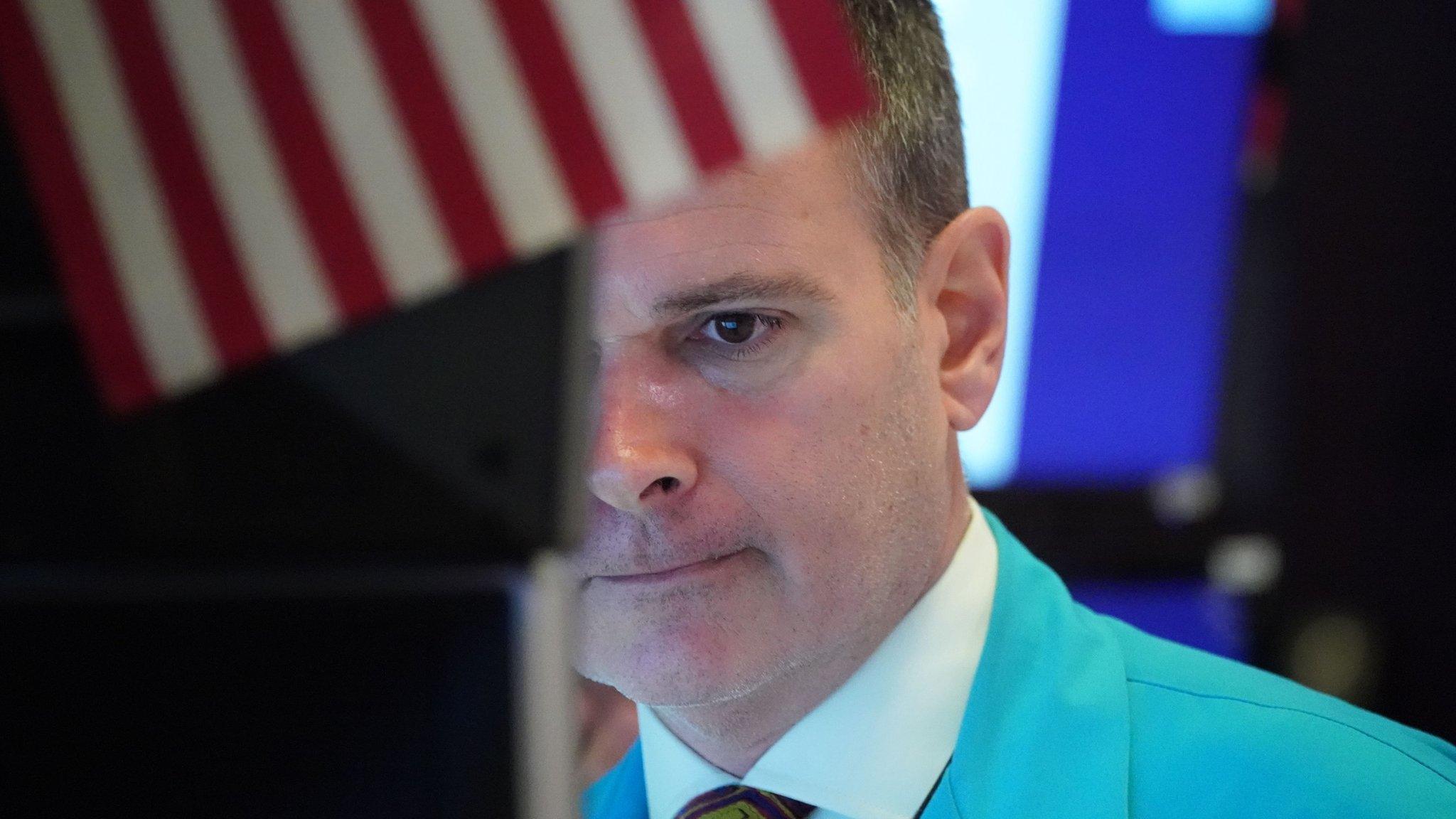 Traders work on the floor at the opening bell of the Dow Industrial Average at the New York Stock Exchange on March 18, 2020 in New York.